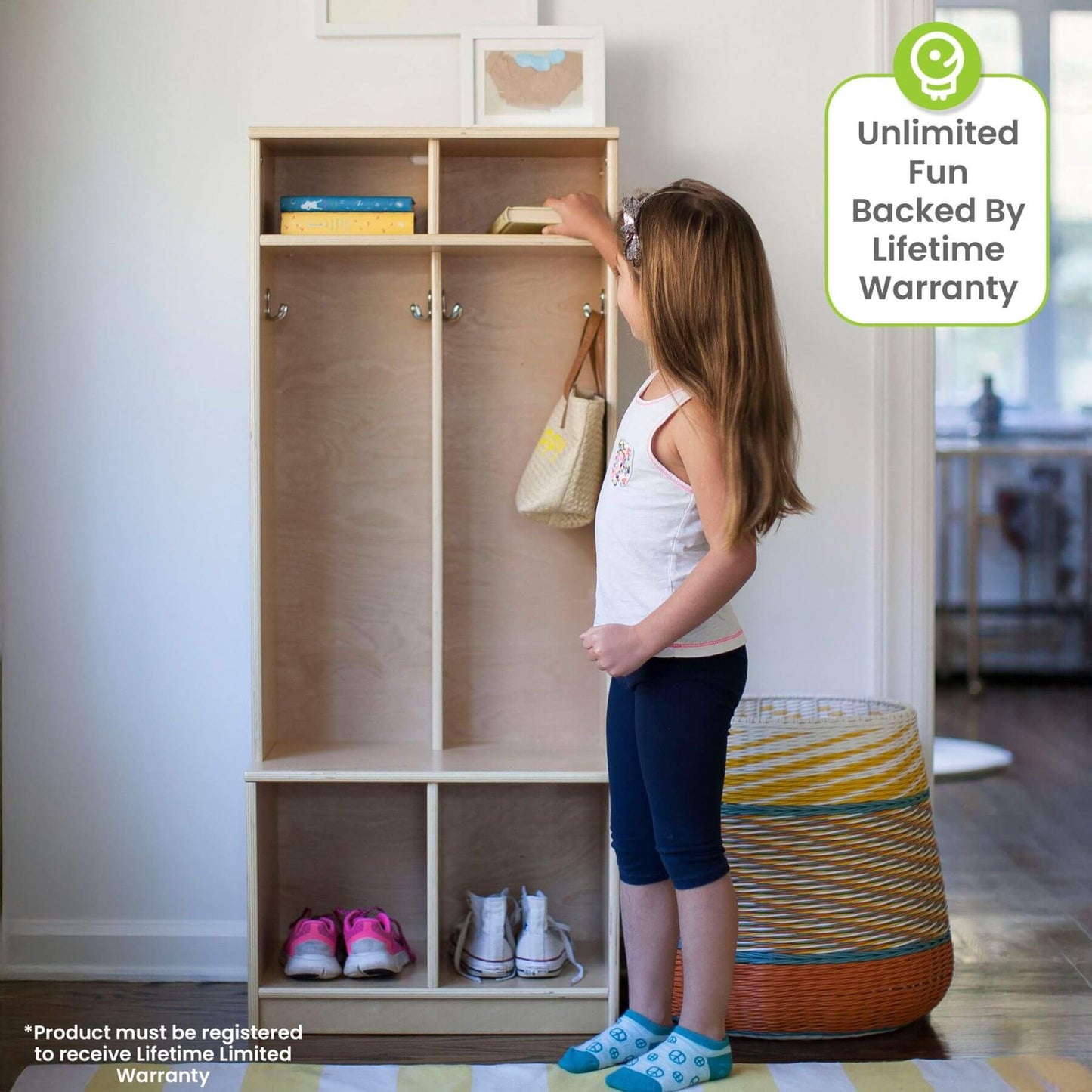 Child interacting with a Little Partners Learn 'N Store Cubby Natural in a room with a basket and shoes.