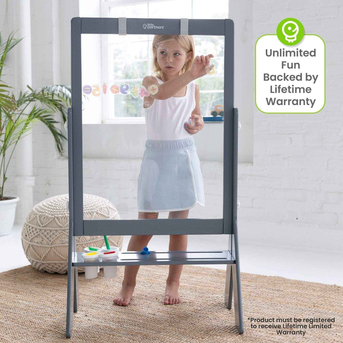 Girl Drawing on Little Partners Peek-A-Boo Easel Grey