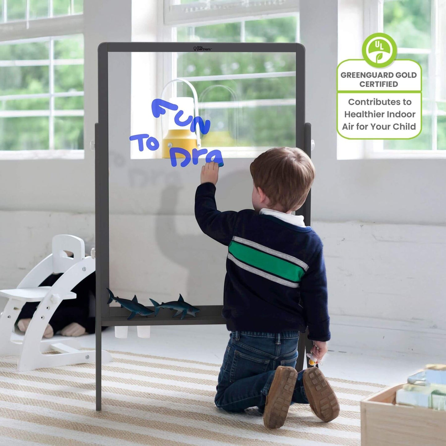 Boy Drawing on Little Partners Peek-A-Boo Easel Grey