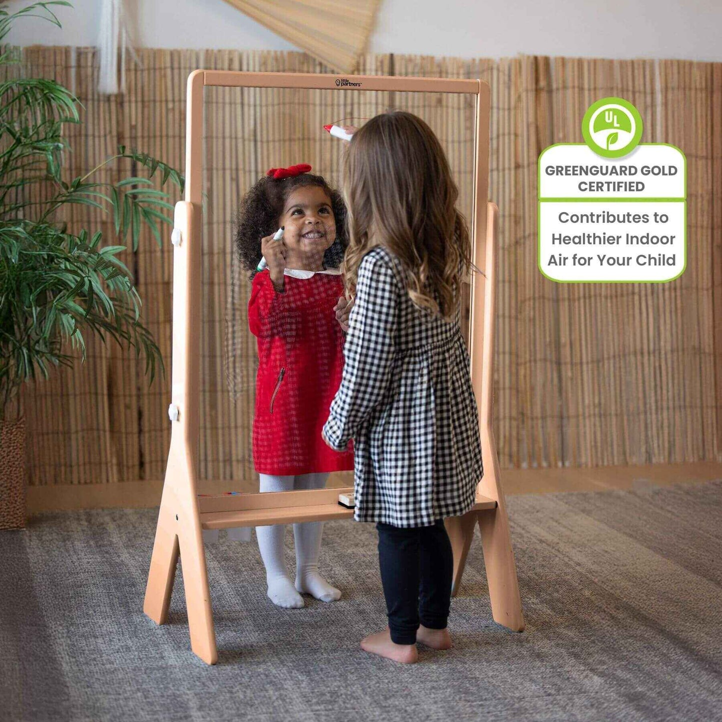 Girls Drawing on both sides of Little Partners Peek-A-Boo Easel Natural