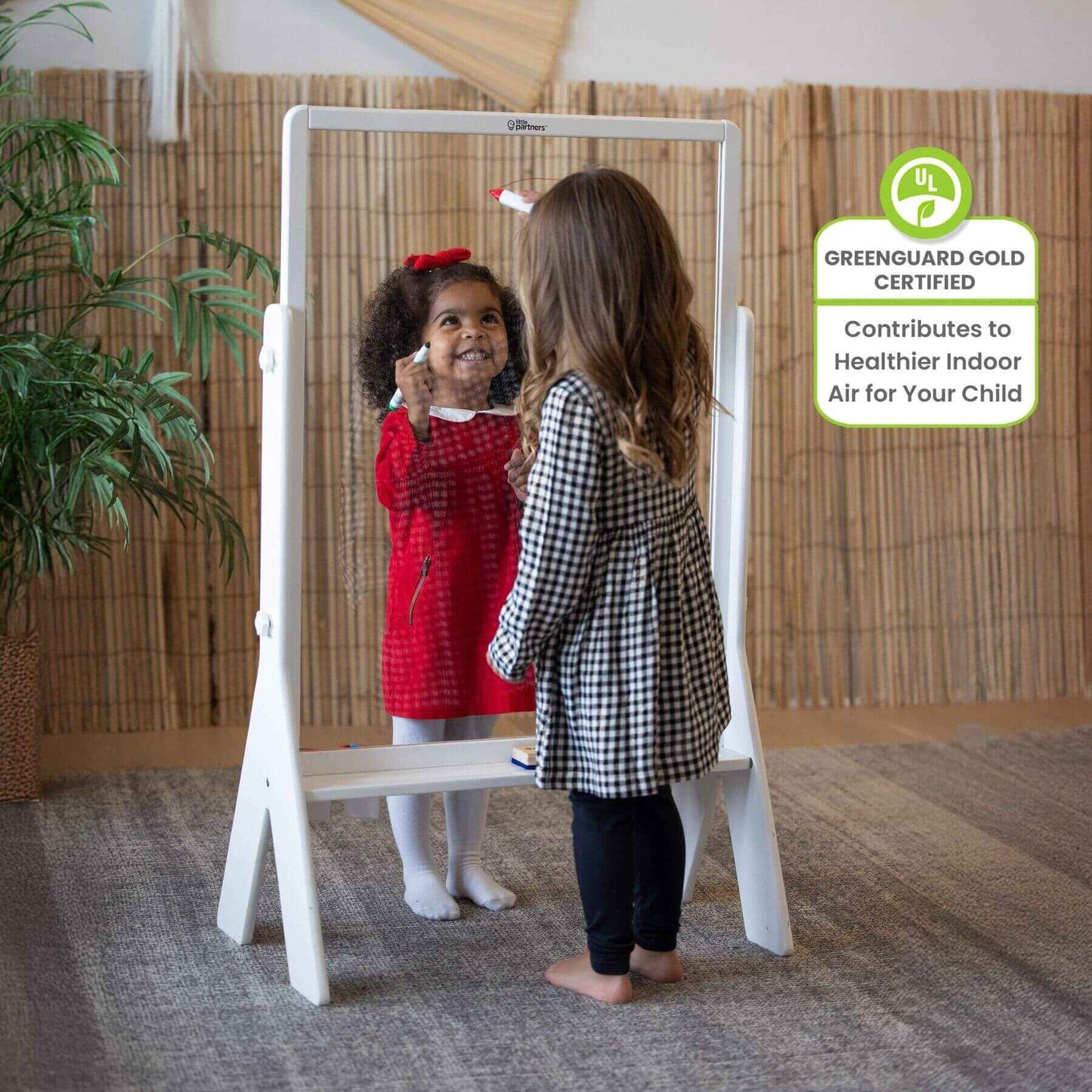 Girls Drawing on both sides of Little Partners Peek-A-Boo Easel White