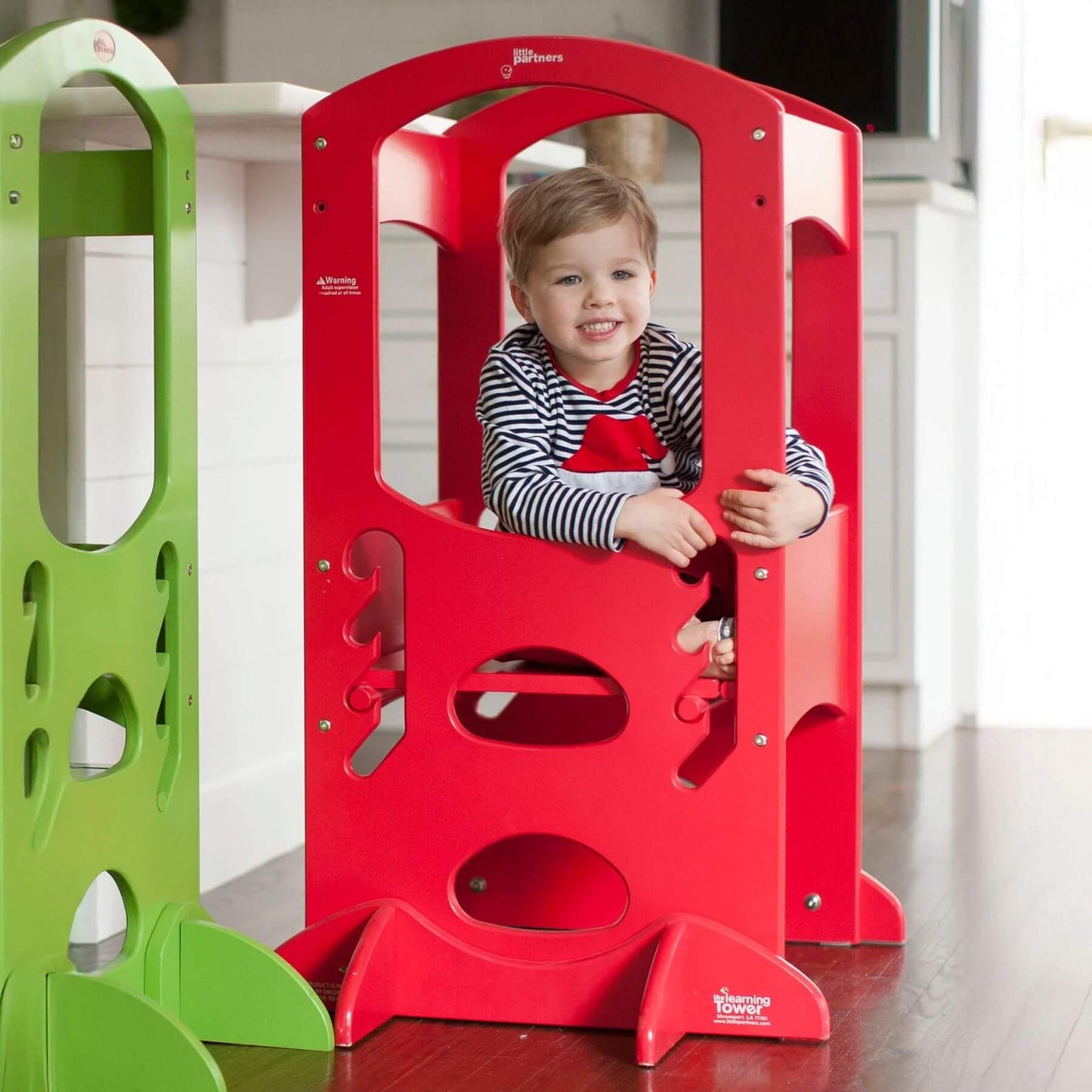 Boy Sitting on the platform of Little Partners The Learning Tower Red