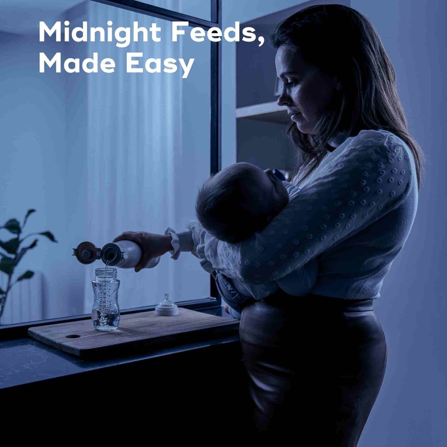 Woman holding a baby with Moov & Feed Portable Milk and Water Warmer and cup on a window sill at night, text 'Midnight Feeds, Made Easy' above.