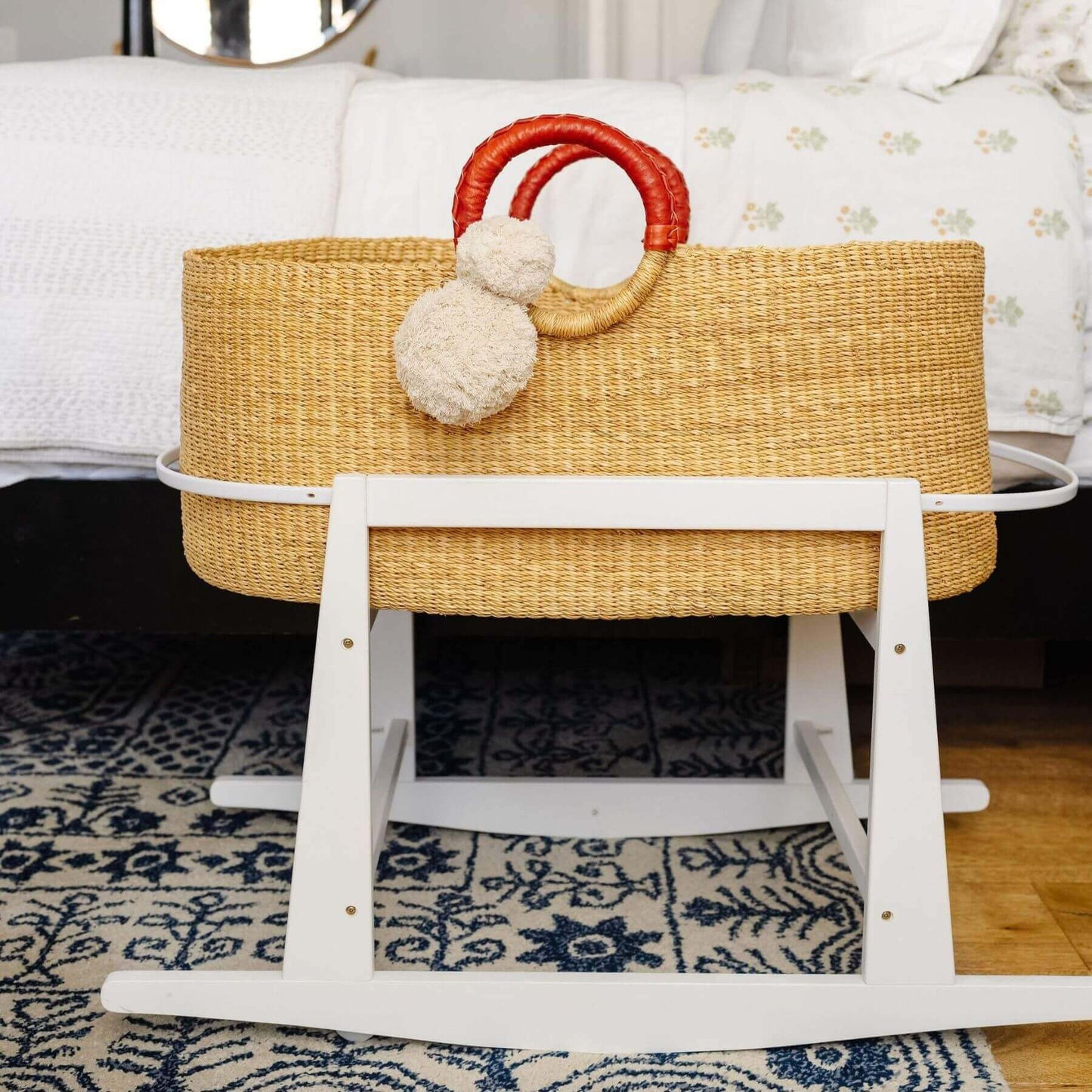 African Moses Basket Cognac Circle Handle on a stand in a home setting.