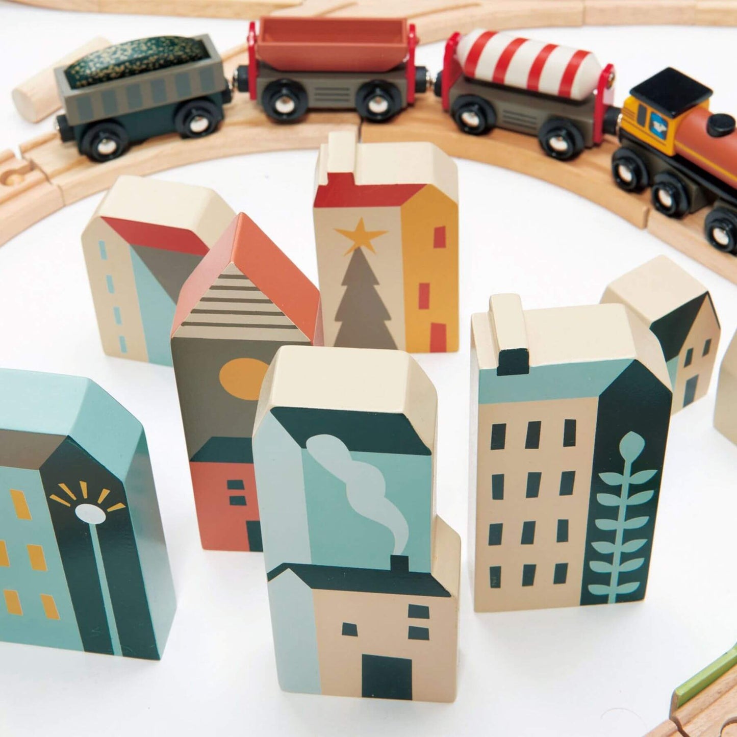 Wooden toy train set with colorful houses on a white background