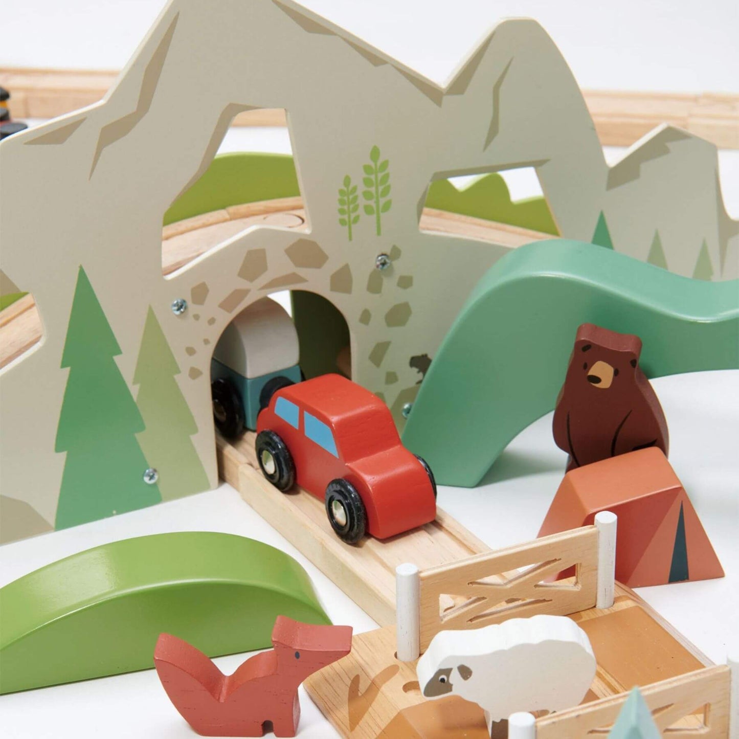 Wooden toy set with animals and a bridge in a forest setting