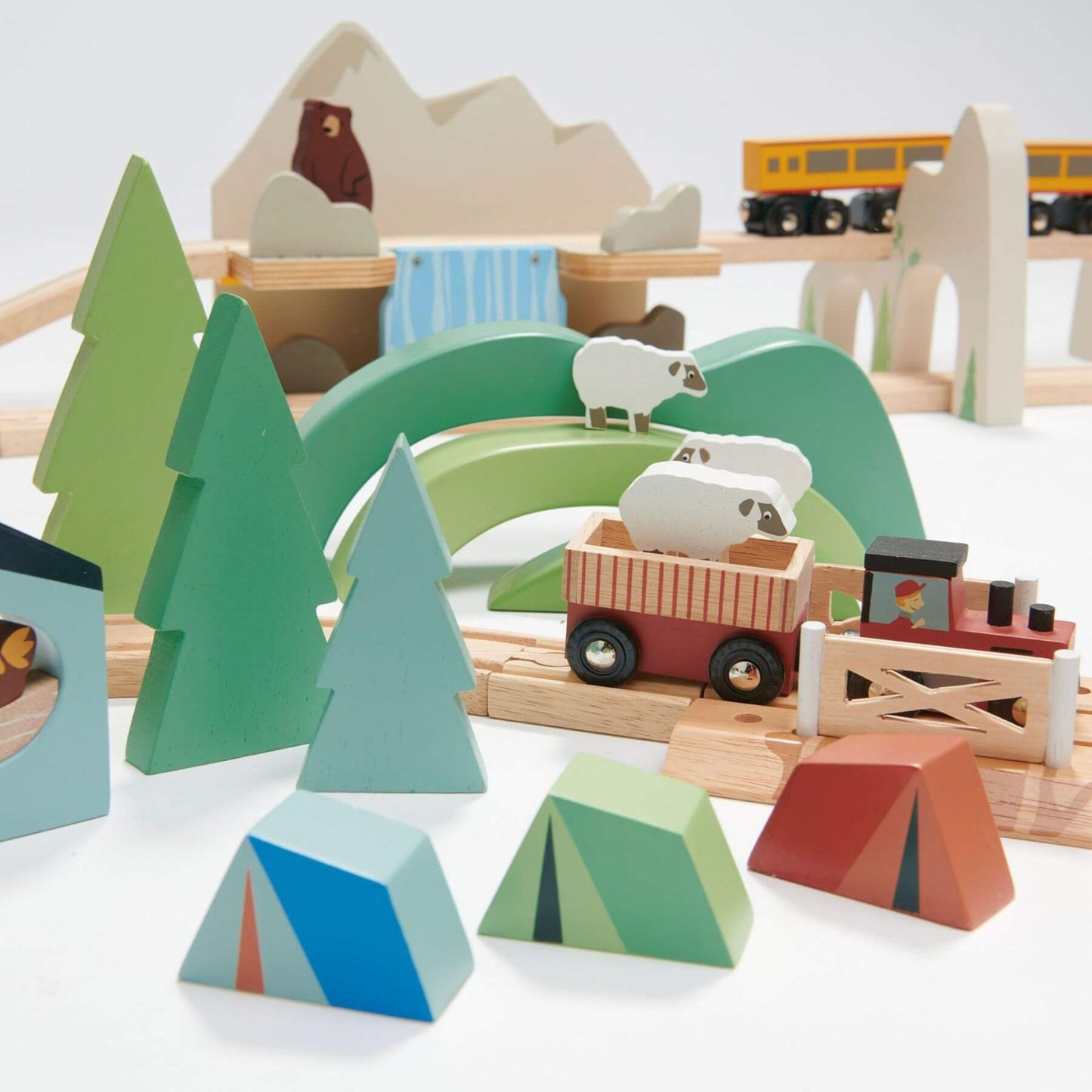 Wooden toy set with animals, trees, and vehicles on a white background