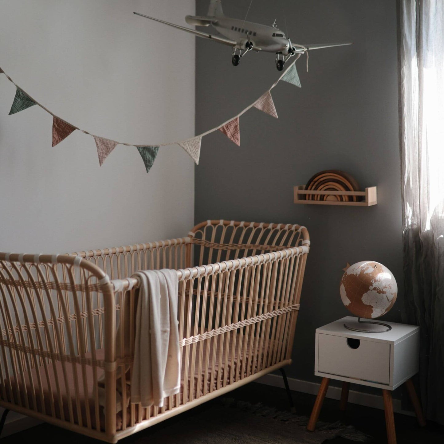 Mushie Organic Cotton Baby Garland above Crib