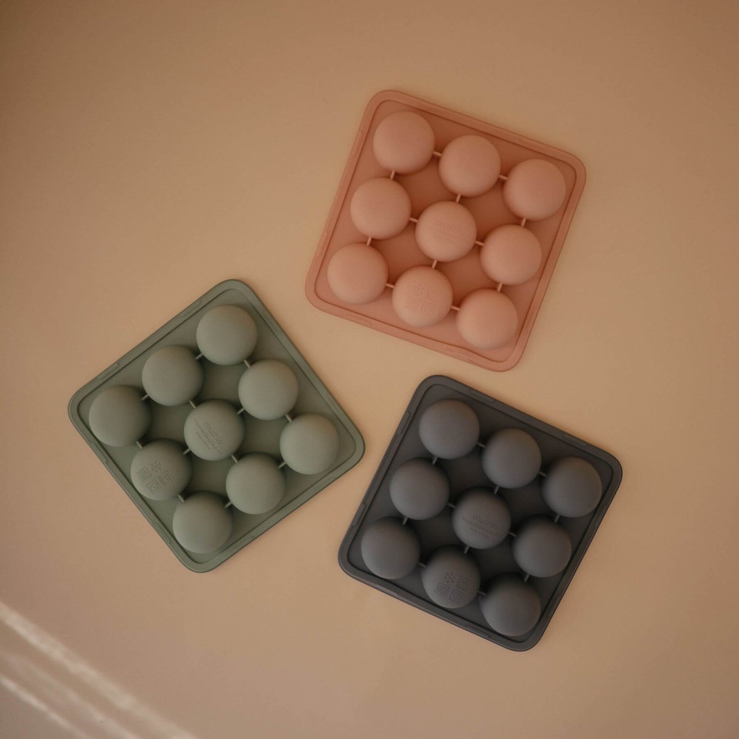 ThreeMushie Baby Food Freezer Trays on a beige surface