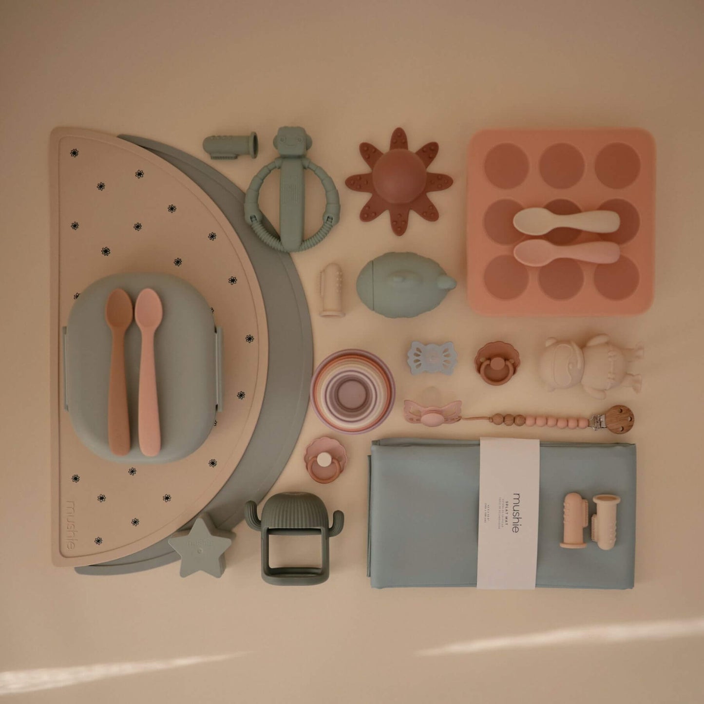 Collection of children's toys and utensils on a neutral background