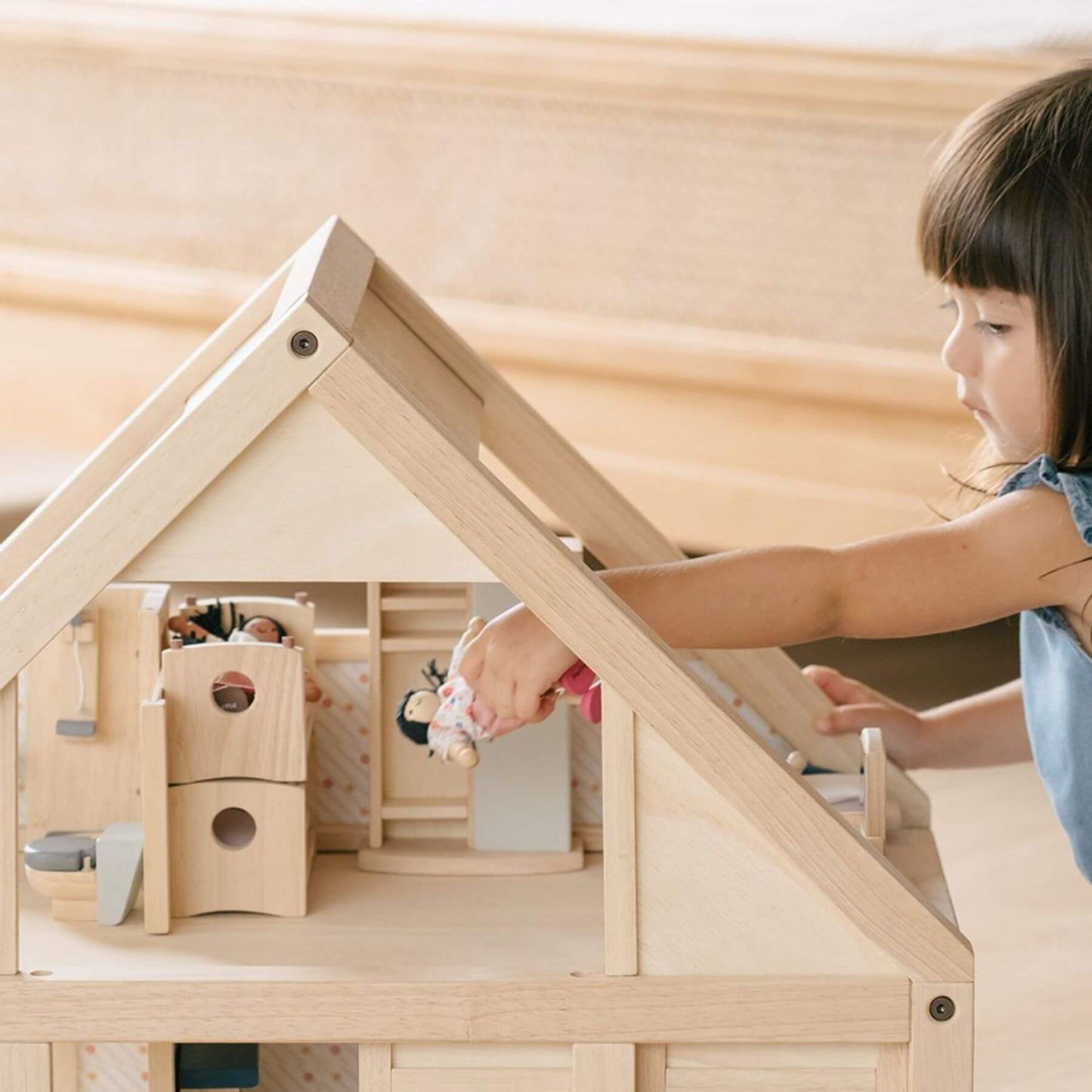 Child playing with PlanToys My First Dollhouse