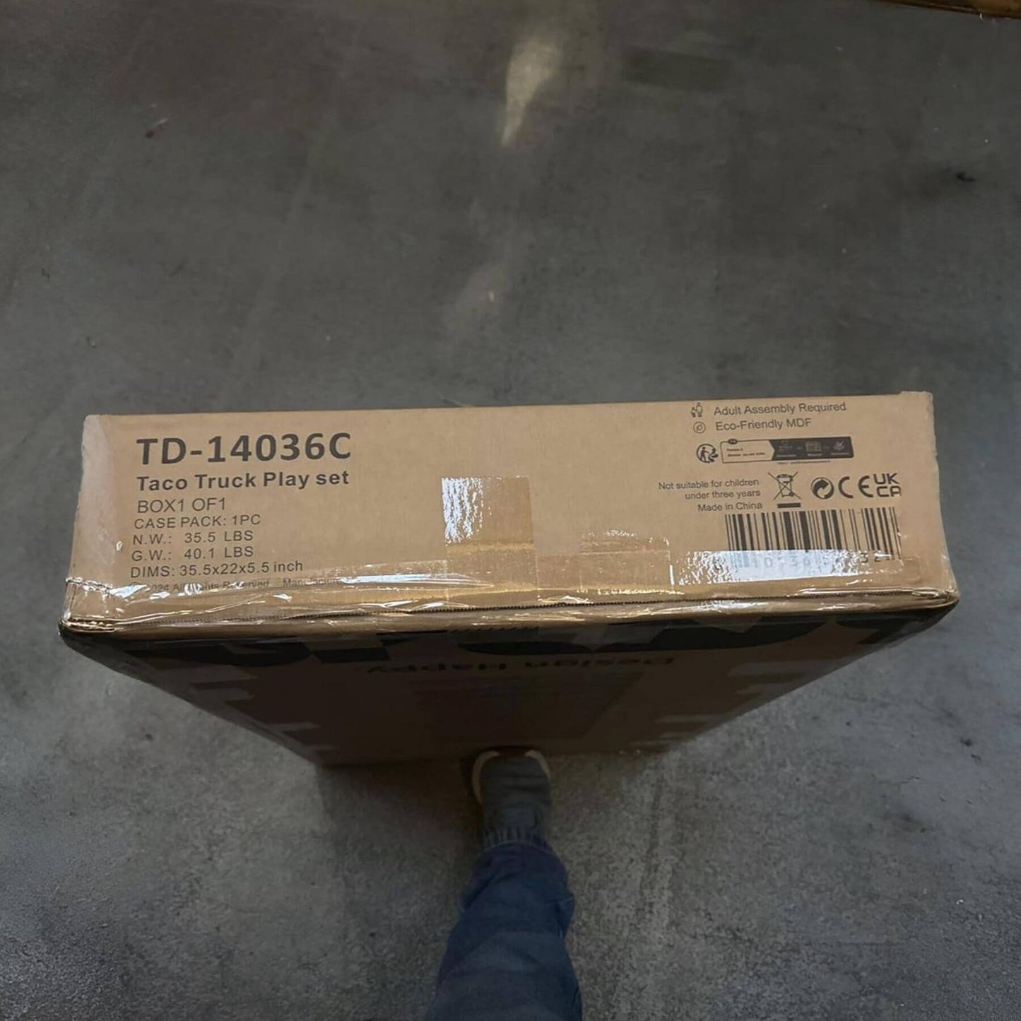 Cardboard box with 'TD-14036C' on a concrete floor