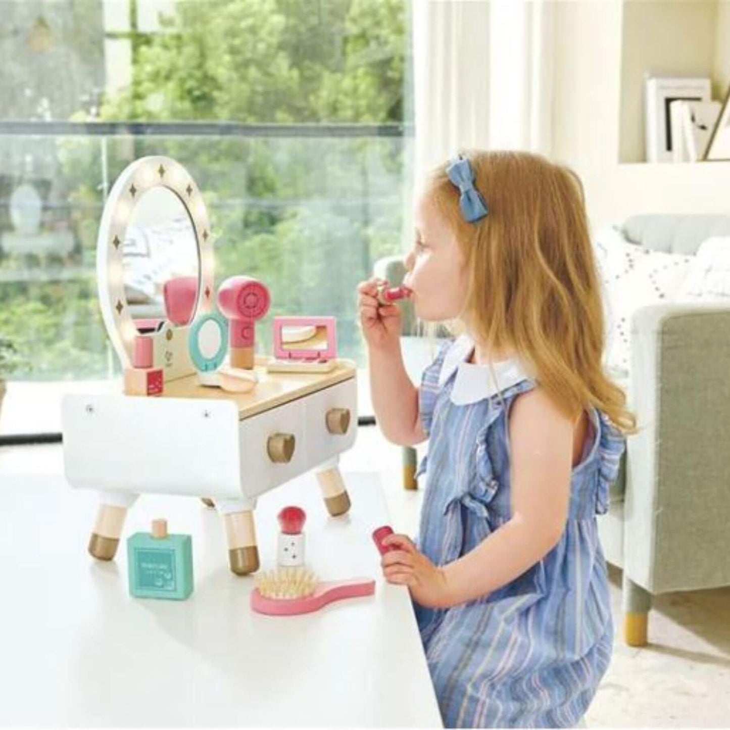 Girl Playing Doing Make Up in front of Hape My Stylish Dressing Table