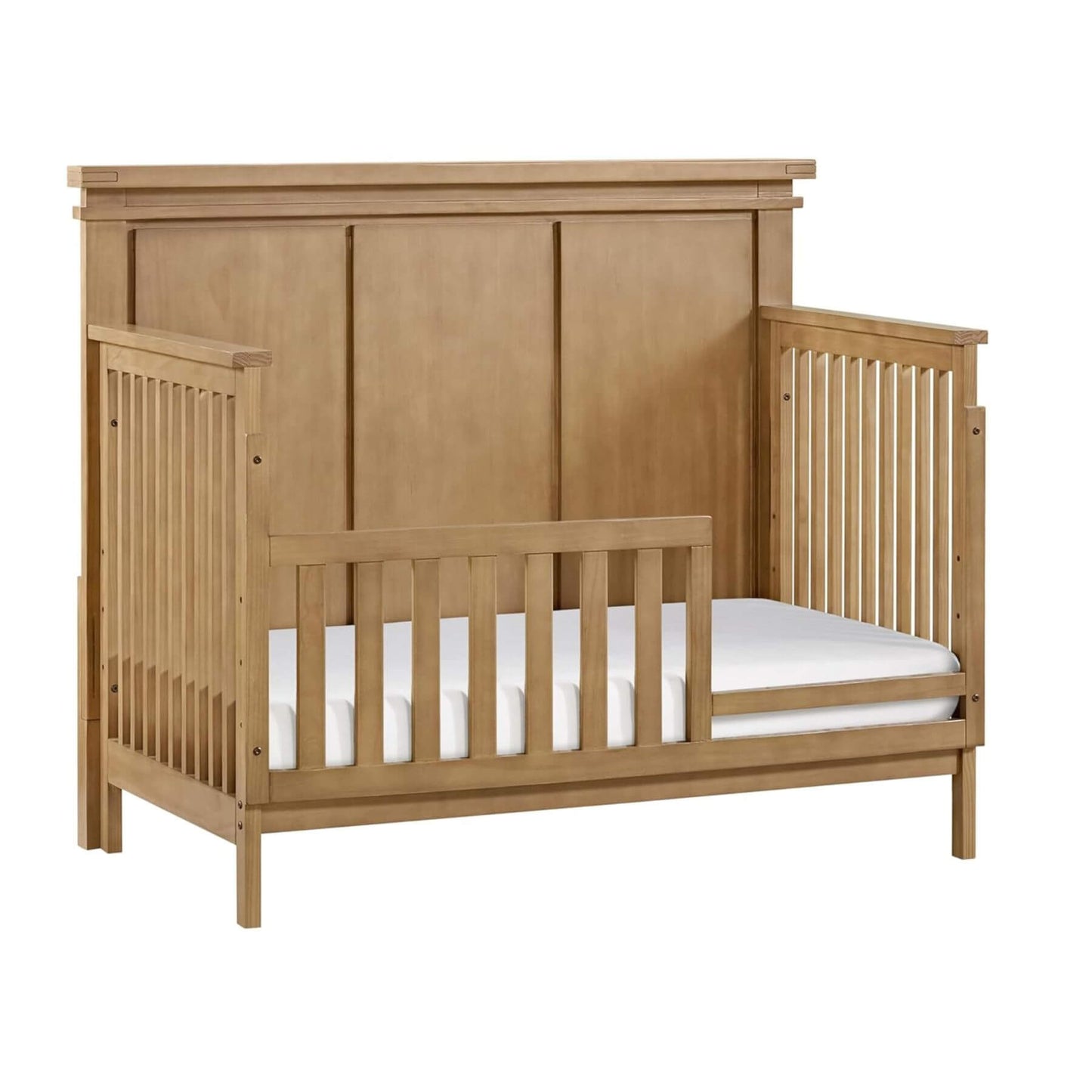 Wooden crib with white mattress on a white background