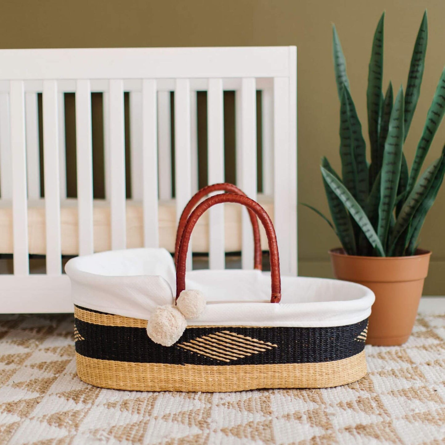 Plum+Sparrow Nightfall African Moses Basket in a nursery setting.