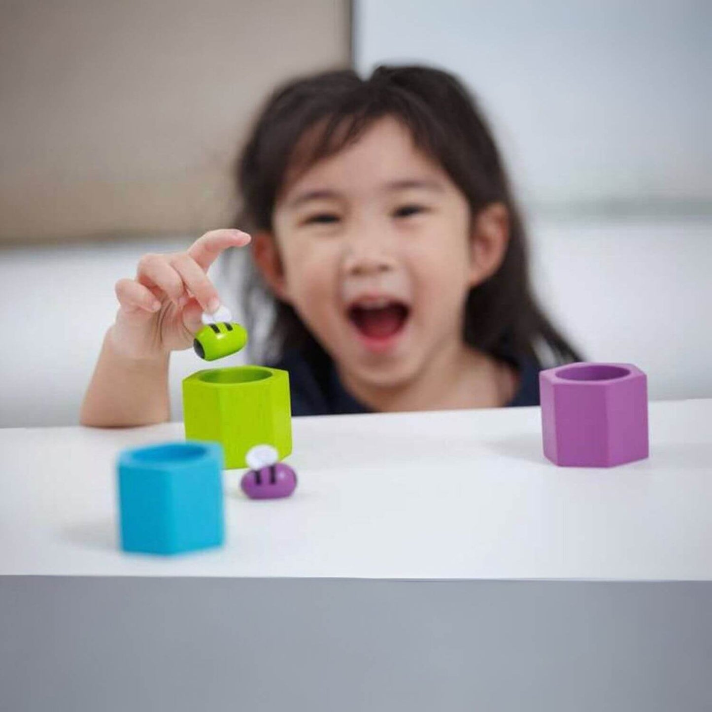 Girl Playing PlanToys Beehives