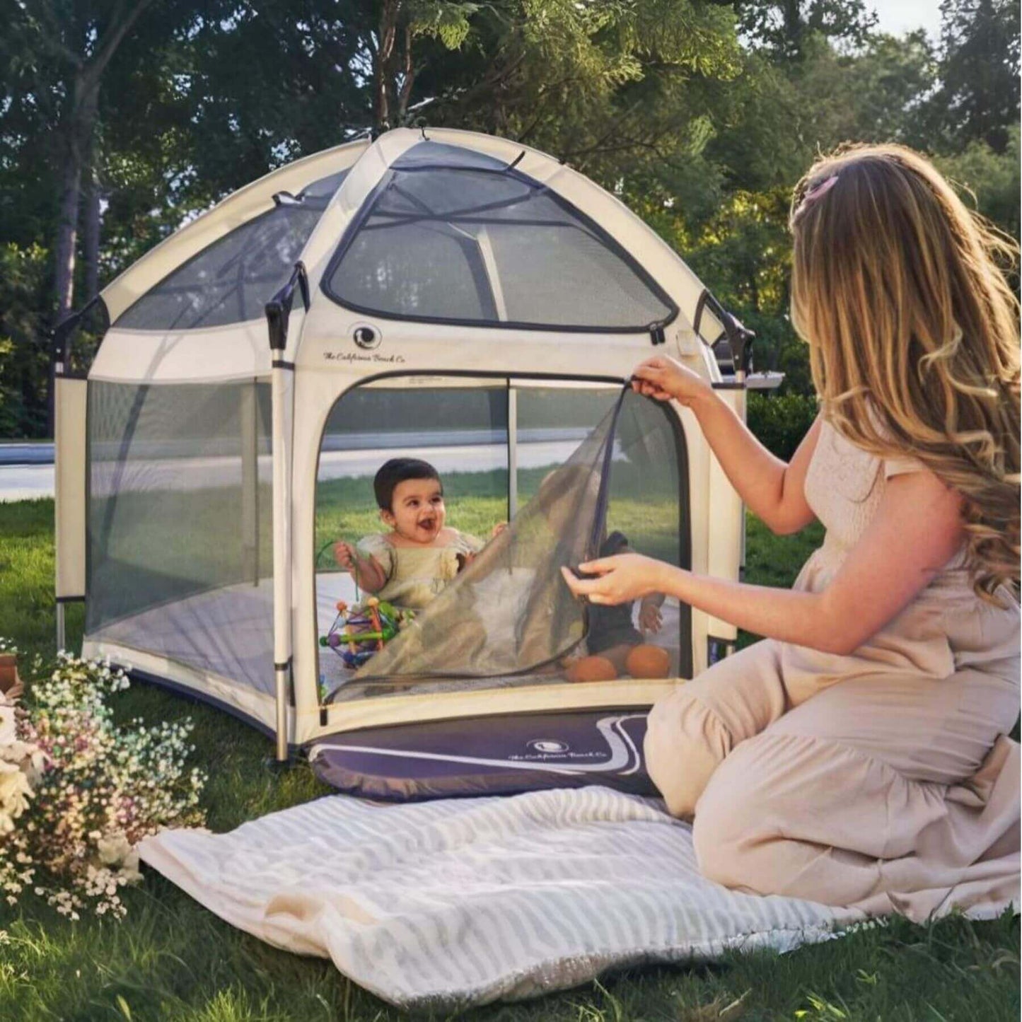 Baby Playing inside Pop 'N Go™ Playpen Ivory, with Mom outside