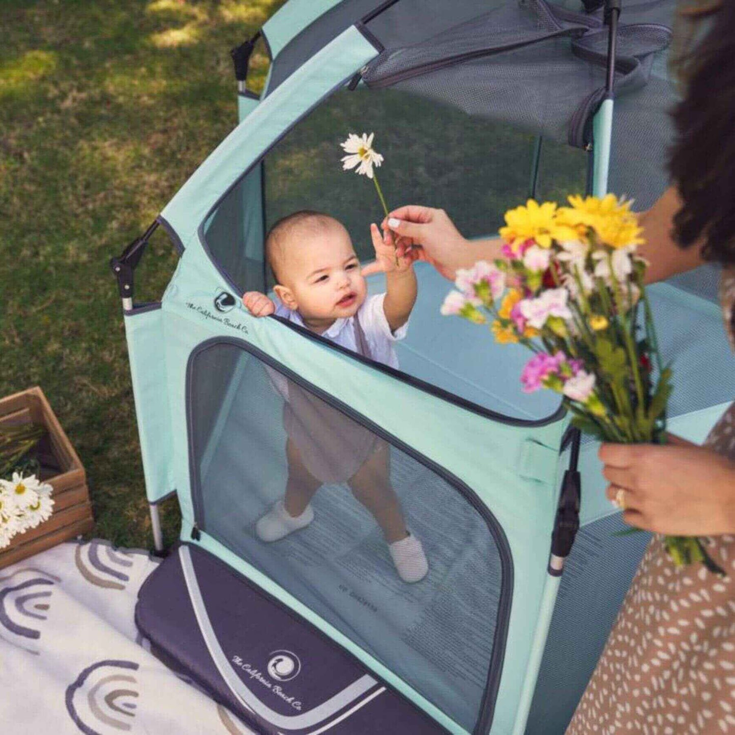 Baby Playing inside The California Beach Co. Pop 'N Go™ Playpen Mint