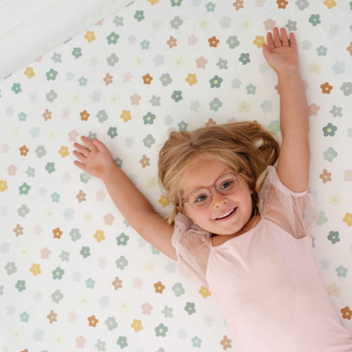 Child lying on Toki Kids Playful Posies Vegan Leather Mat