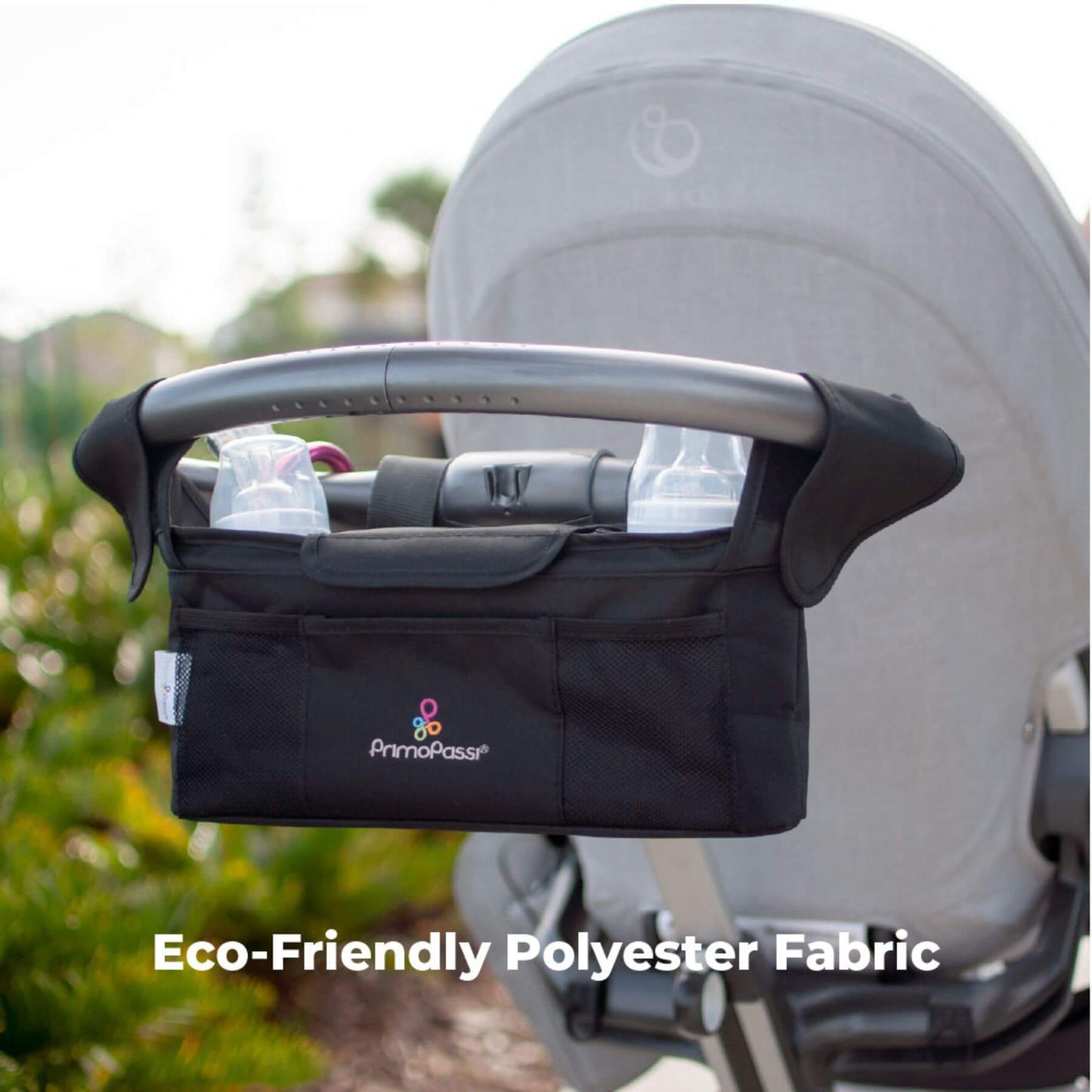 Primo Passi Stroller Handle Organizer attached to a stroller with text 'Eco-Friendly Polyester Fabric'.