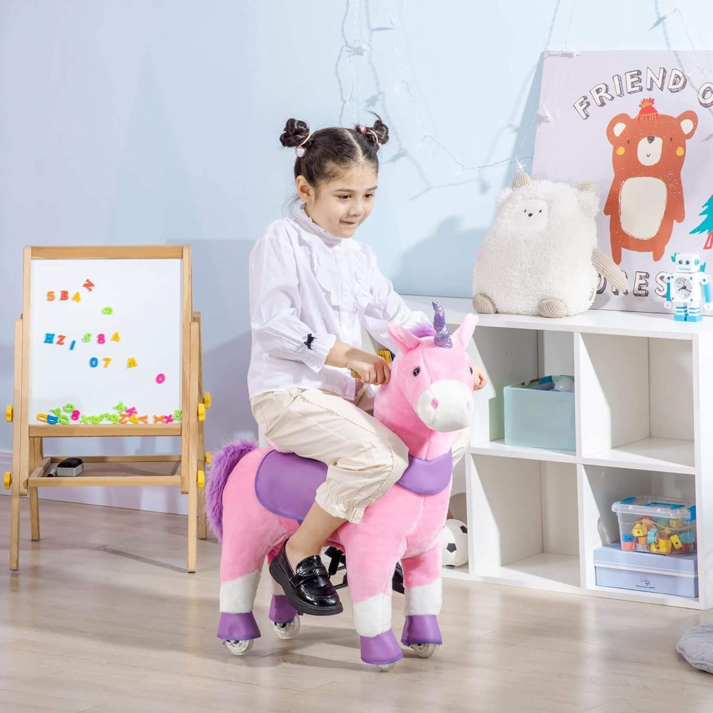 Child riding Qaba Ride On Real Walking Unicorn with Sparkly Horn Pink in a room with educational posters and toys.