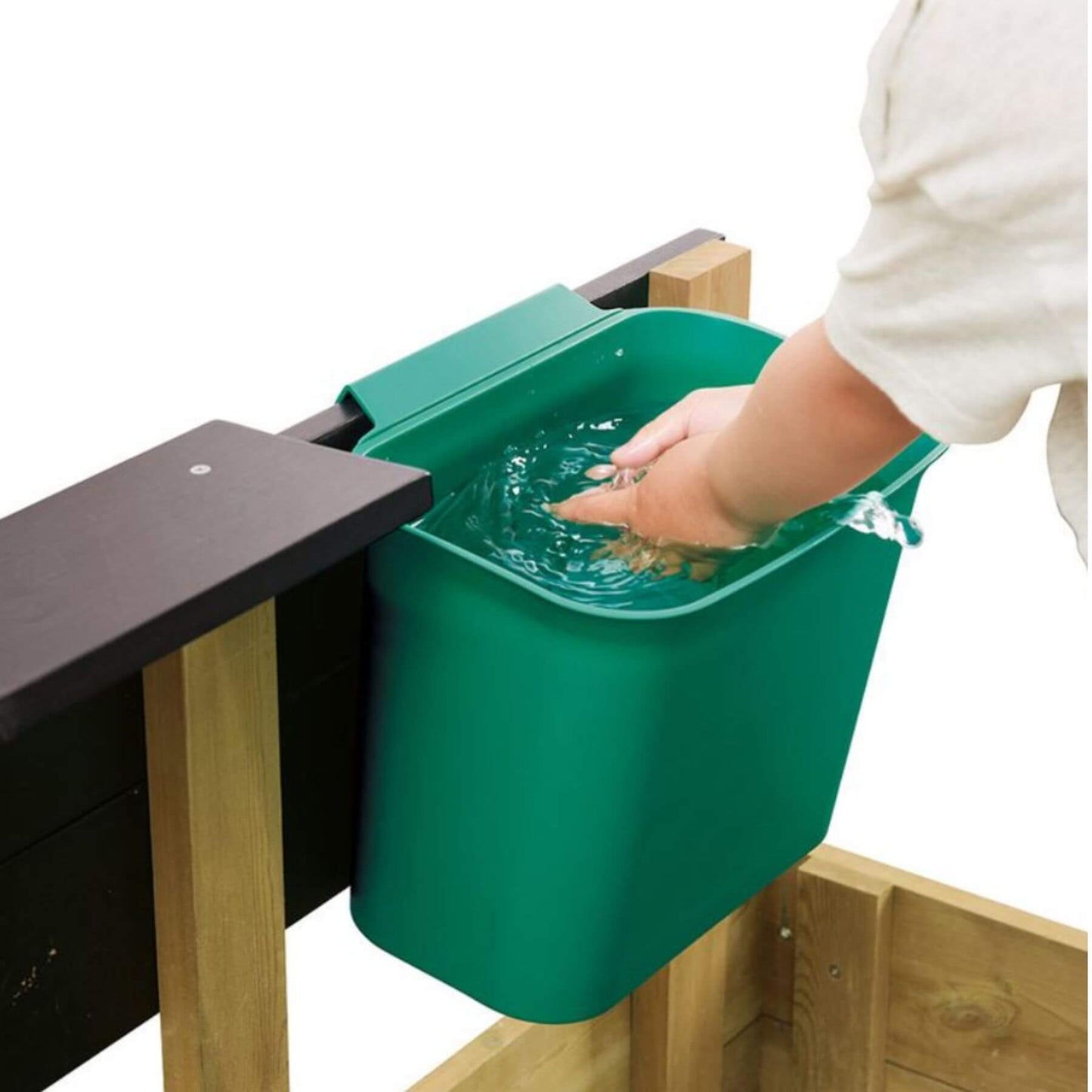 Green compost bin attached to a wooden table with a hand reaching in.