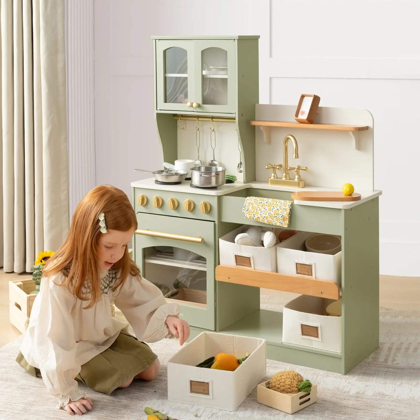 Child playing with Tiny Land® Serenity Play Kitchen Sage Green in a room.