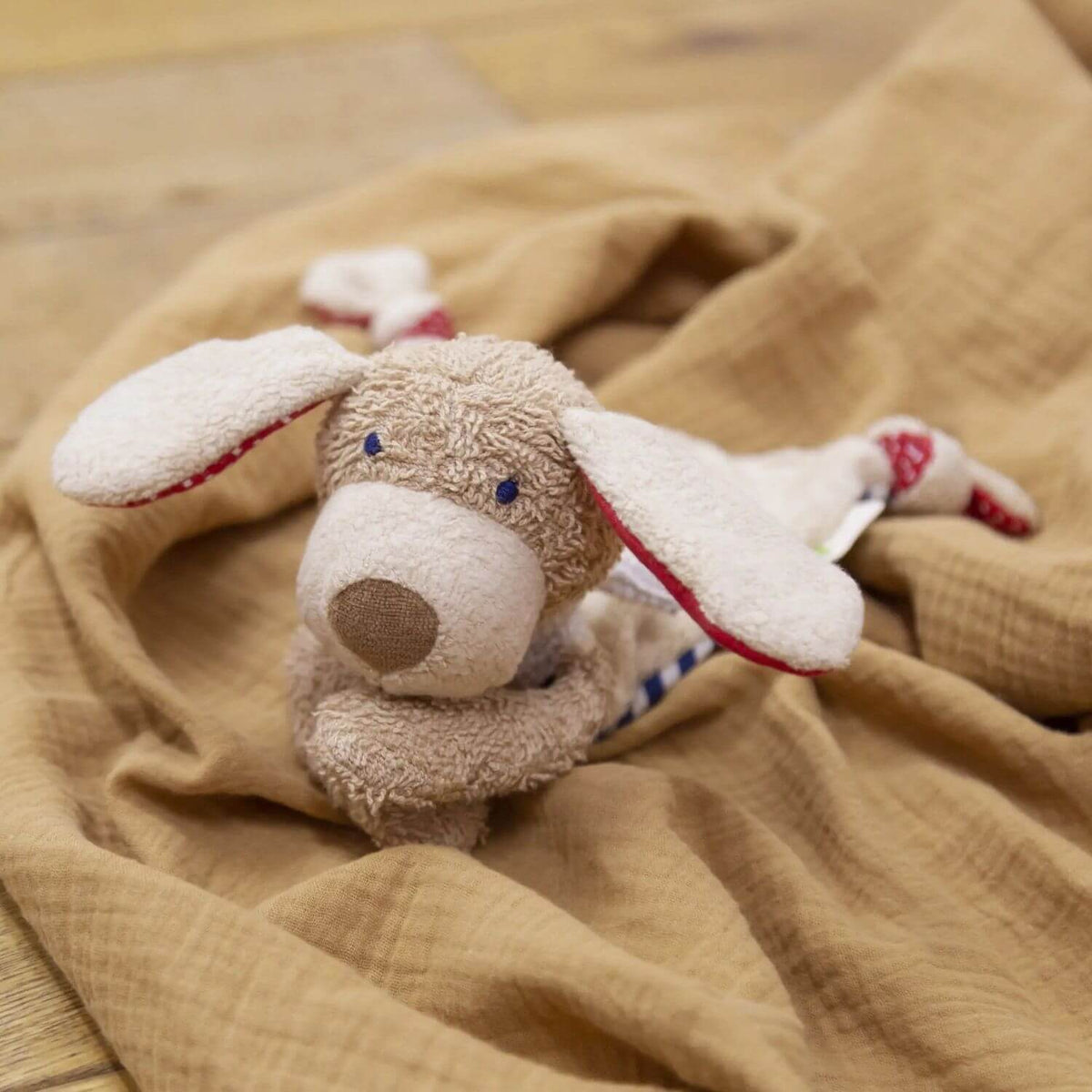 sigikid Organic Dog Blankie on a soft brown blanket