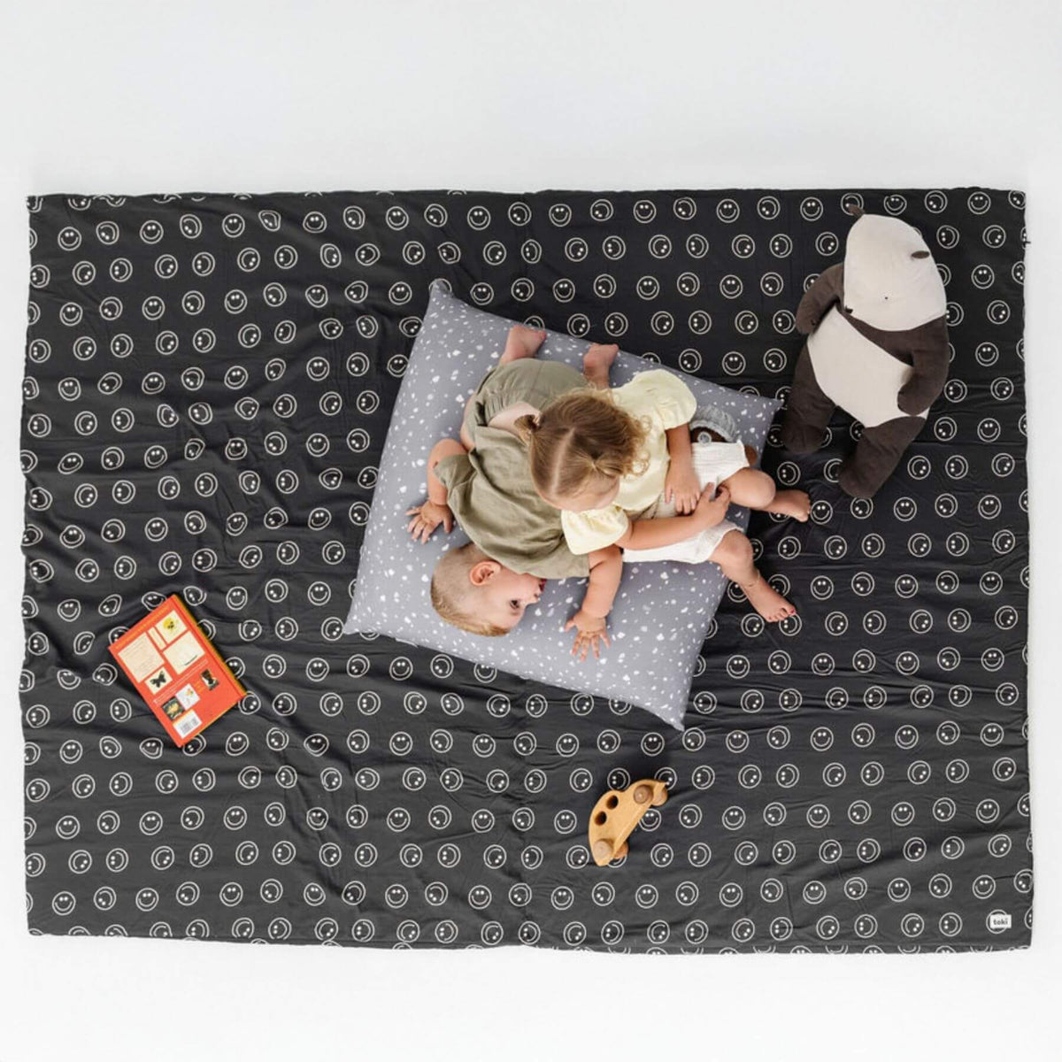 Two children playing on Toki Kids Smiles Organic Cotton Mat