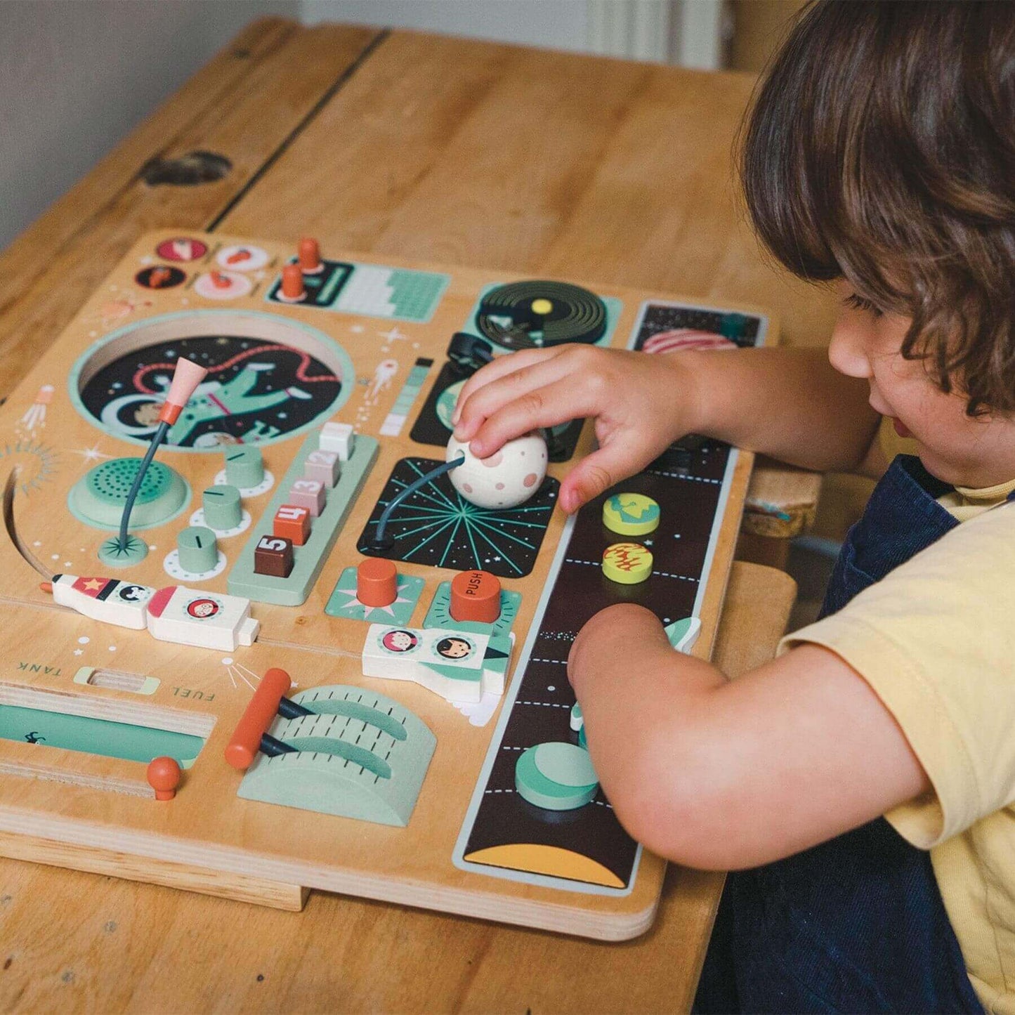 Child playing with Tender Leaf Space Station on a wooden table