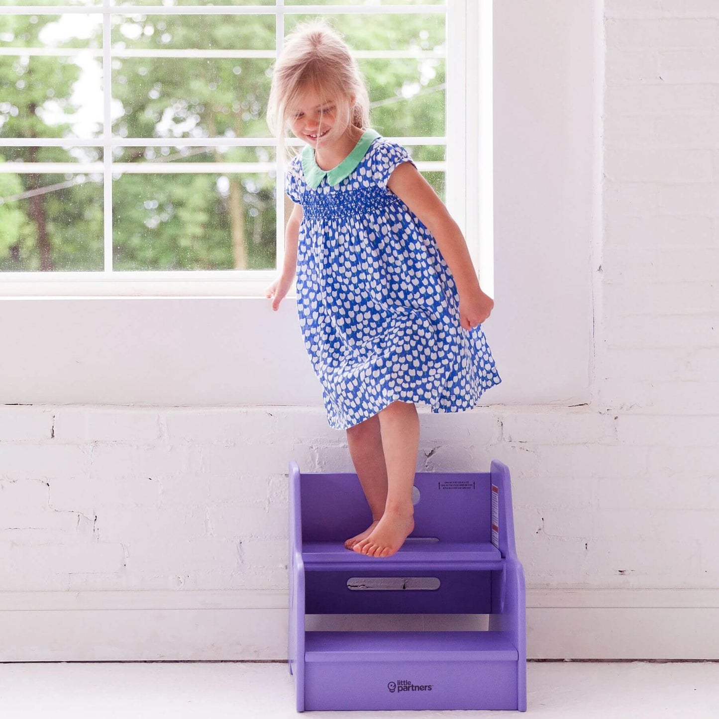 Girl Standing on Little Partners StepUp Step Stool Lilac