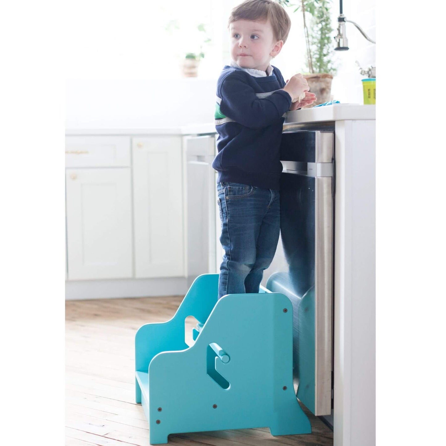 Boy Standing on Little Partners StepUp Step Stool Turquois