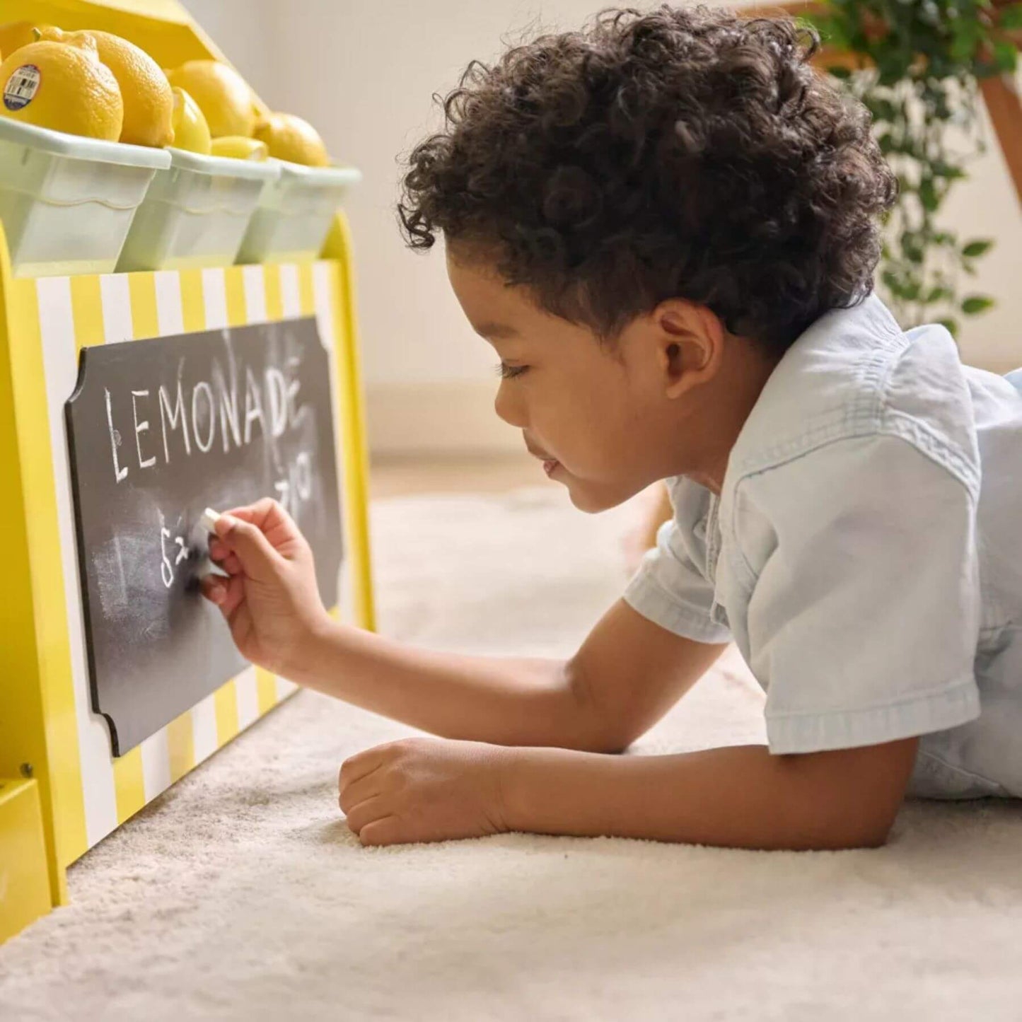 Child playing with Chalk Board on Teamson Sunny Citrus Lemonade Stand Playset