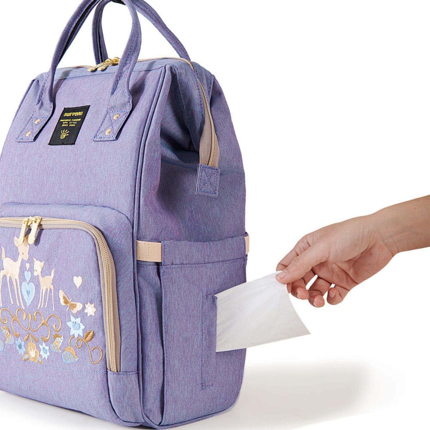 Sunveno Classic Embroidered Diaper Backpack - Purple Deer and a hand holding a piece of paper.