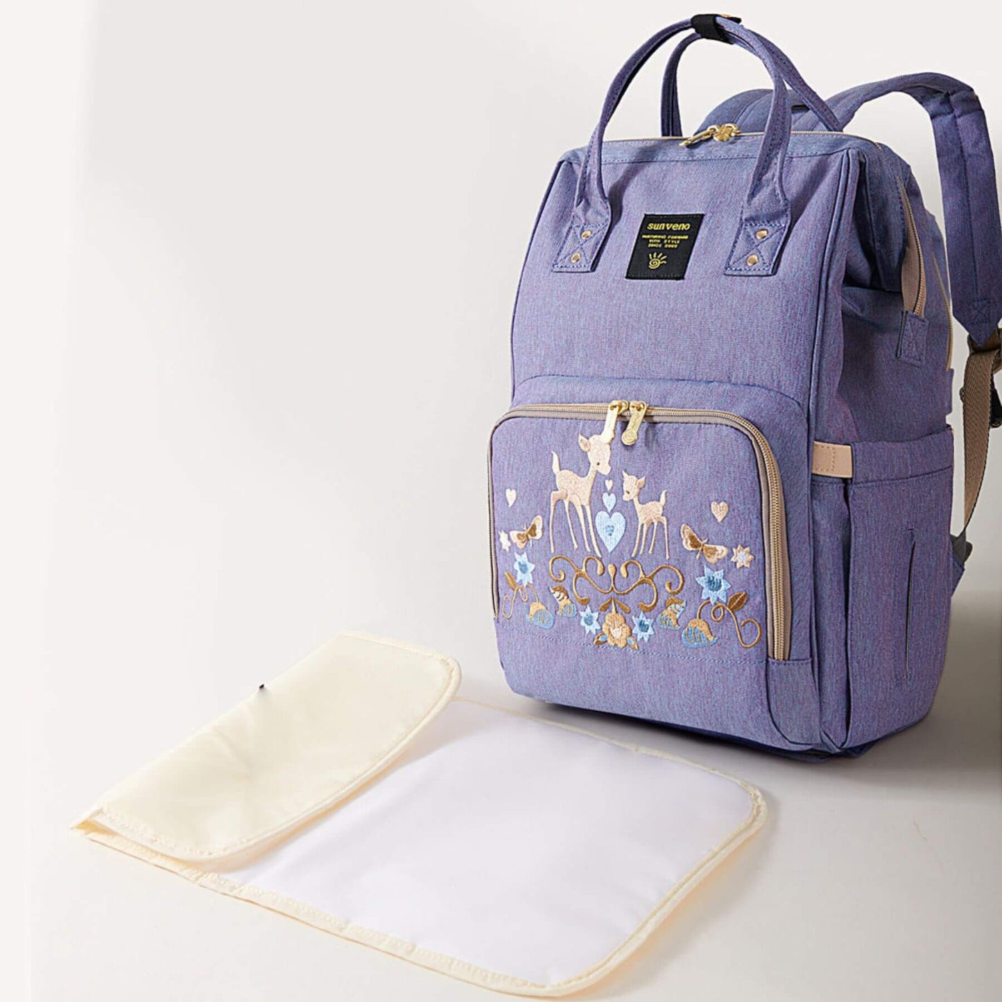 Sunveno Classic Embroidered Diaper Backpack - Purple Deer and a matching changing pad on a light background