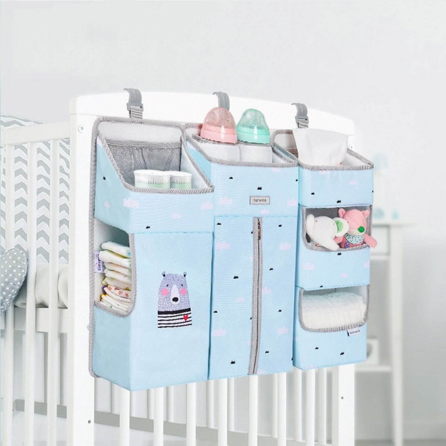 Sunveno 3-in-1 Crib Organizer Blue hanging over a crib with various items inside