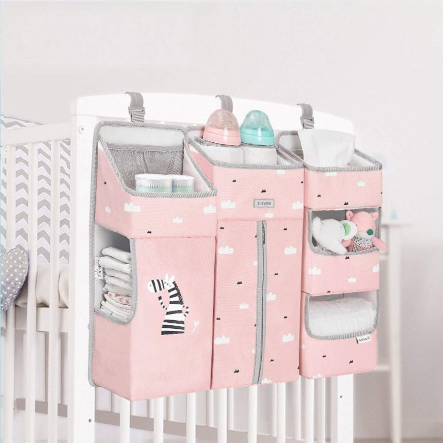 Sunveno 3-in-1 Crib Organizer Pink hanging on a crib with various items inside