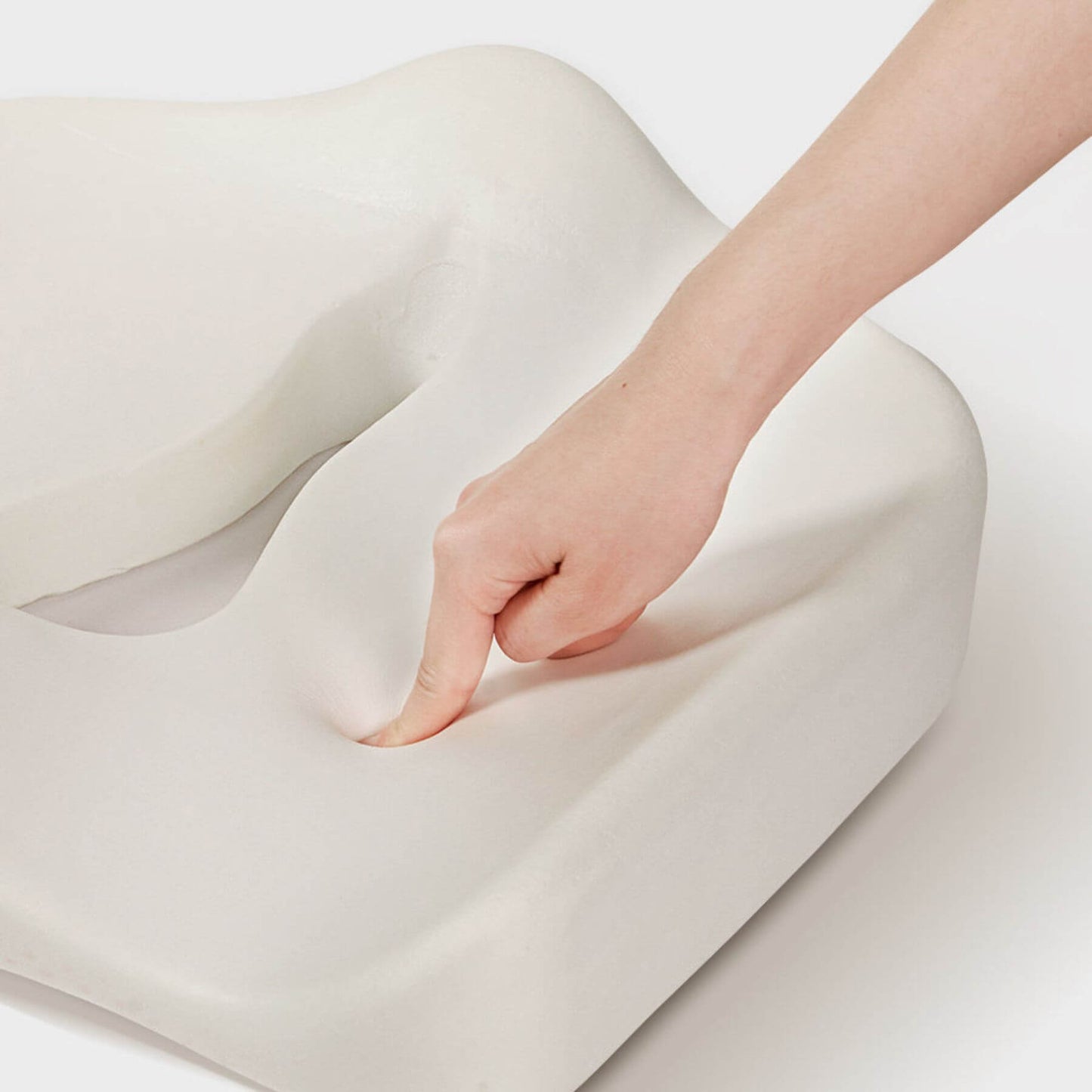 Close-up of a hand touching memory foam
