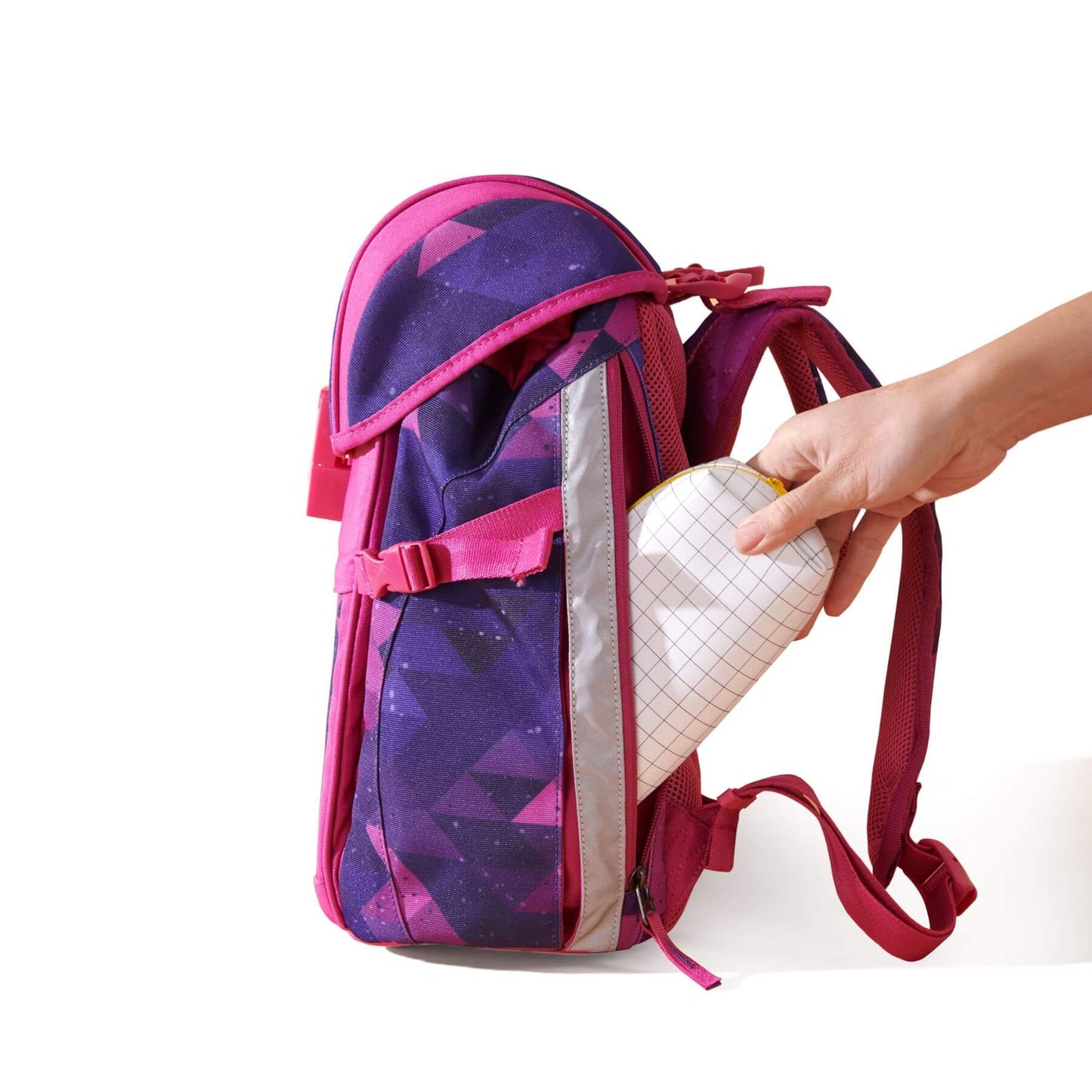 Sunveno Over-clip Kids School Backpack Pink with a hand reaching to open it on a white background