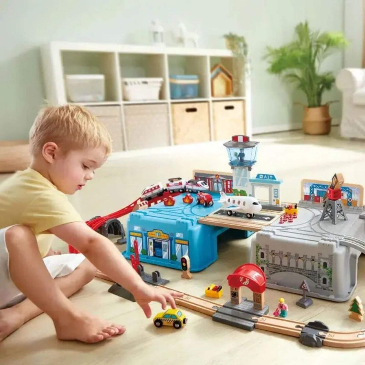 Boy Playing Hape Super Cityscape Transport Bucket Set