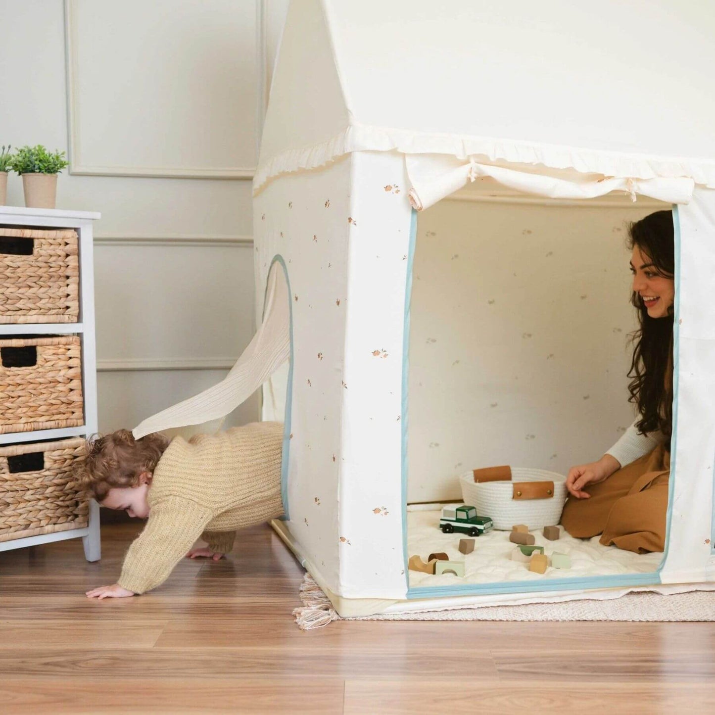 Woman and child playing inside Tiny Land® Sweet Citrus Kid's Play Tent - Creamy white/blue in a room with wooden floor and white walls.