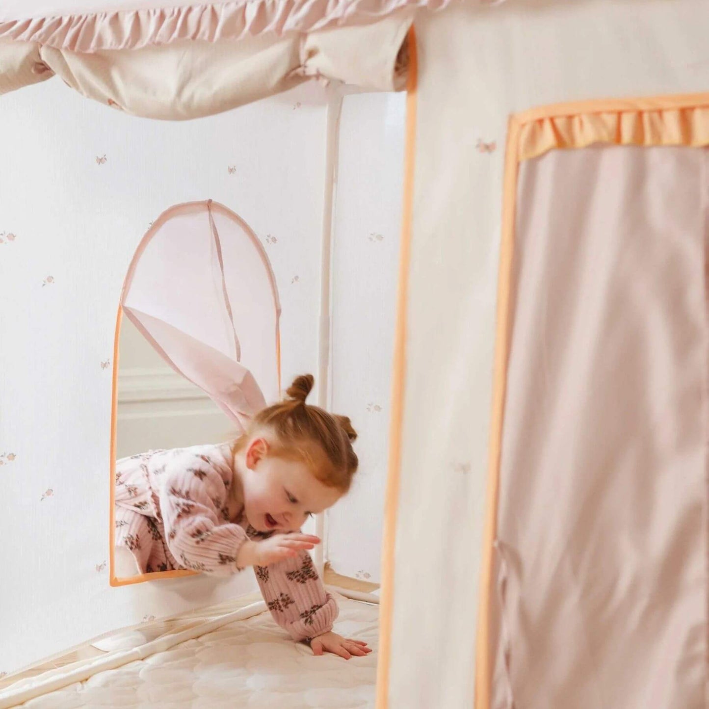 Child playing inside Tiny Land® Sweet Citrus Kid's Play Tent - Creamy white/pink.