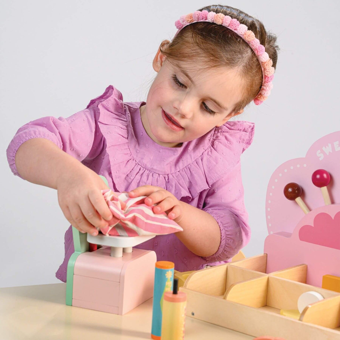 Child playing with Tender Leaf Sweetie Pic'n'Mix Shop on a light gray background