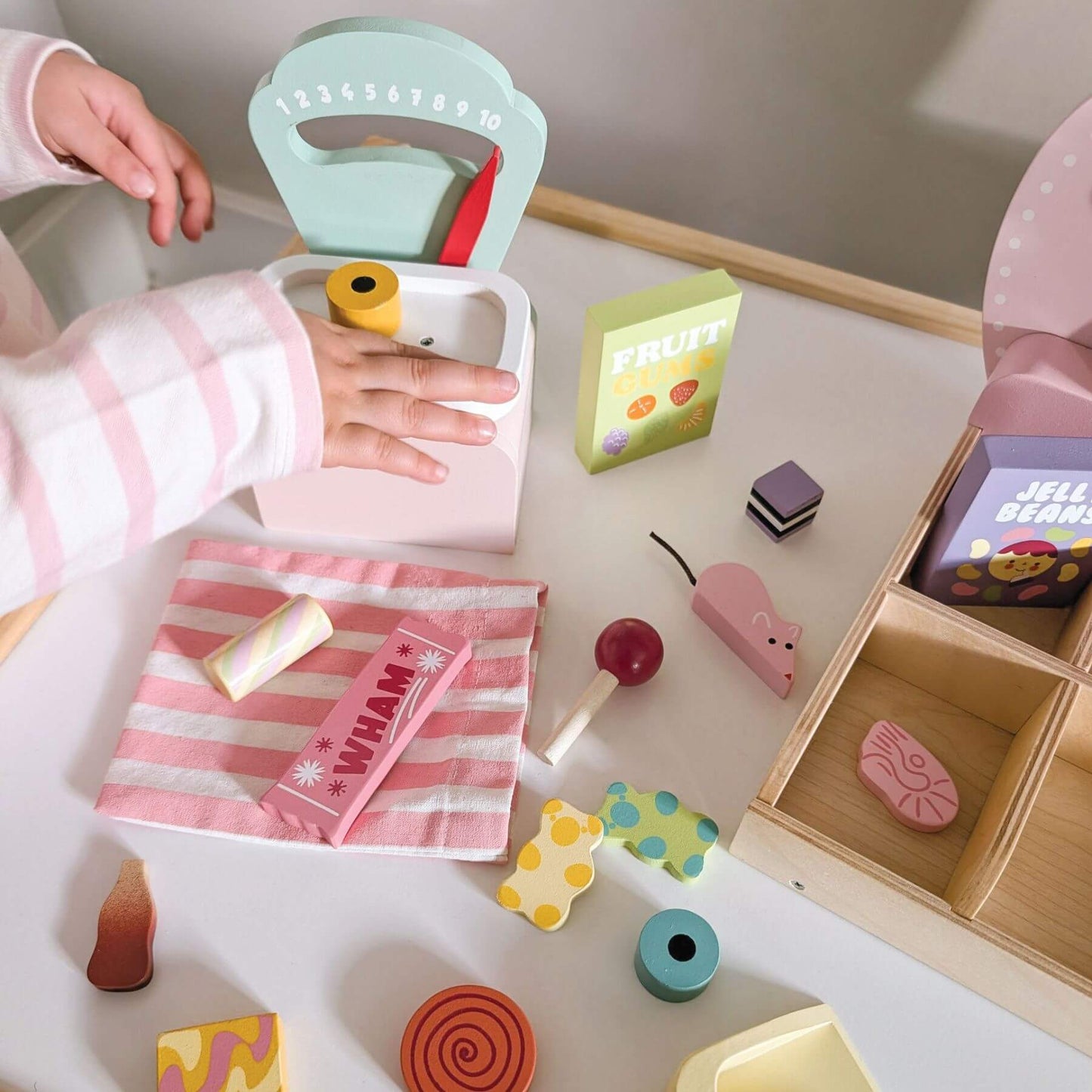 Child playing with Tender Leaf Sweetie Pic'n'Mix Shop on a table