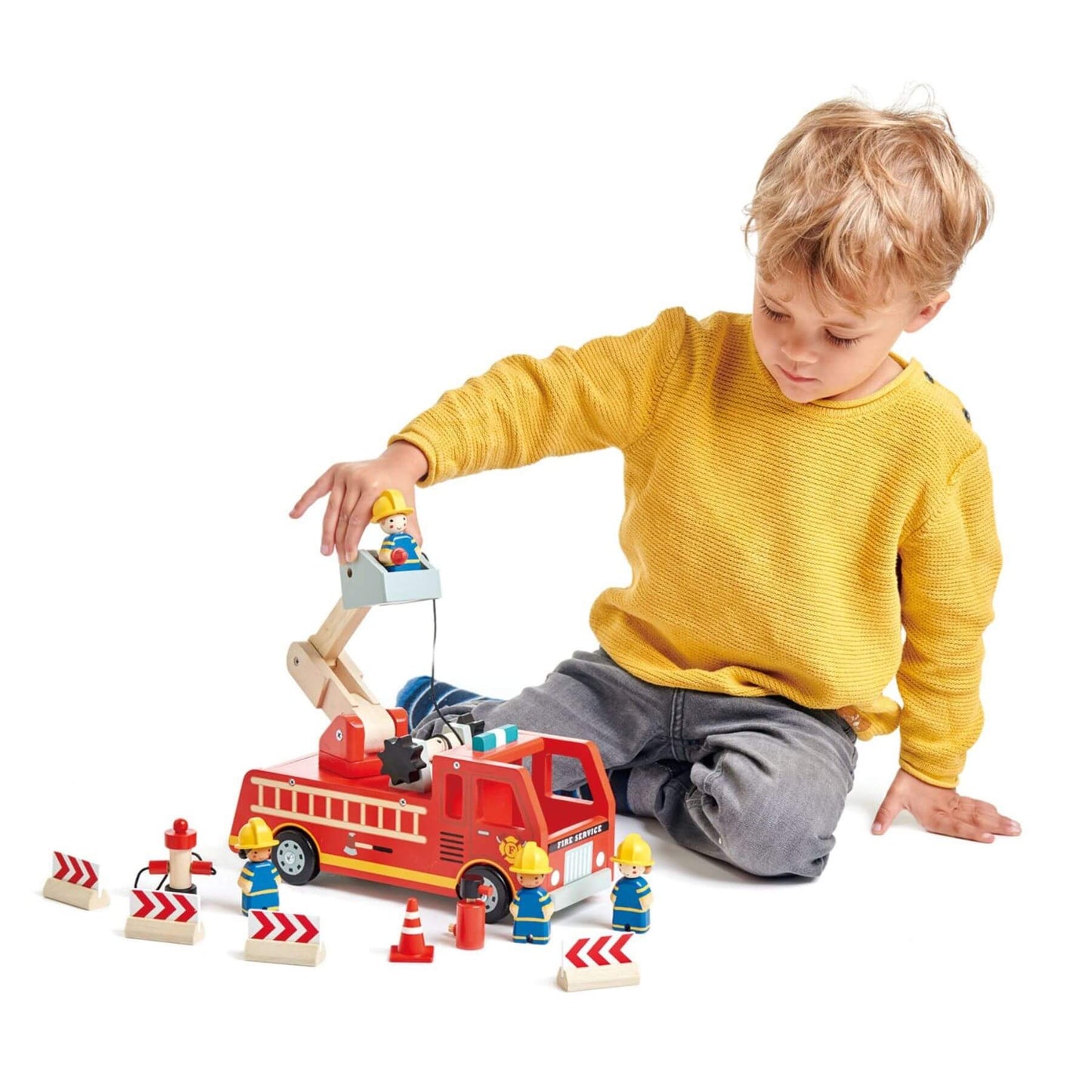 Child playing with Tender Leaf Fire Engine on a white background