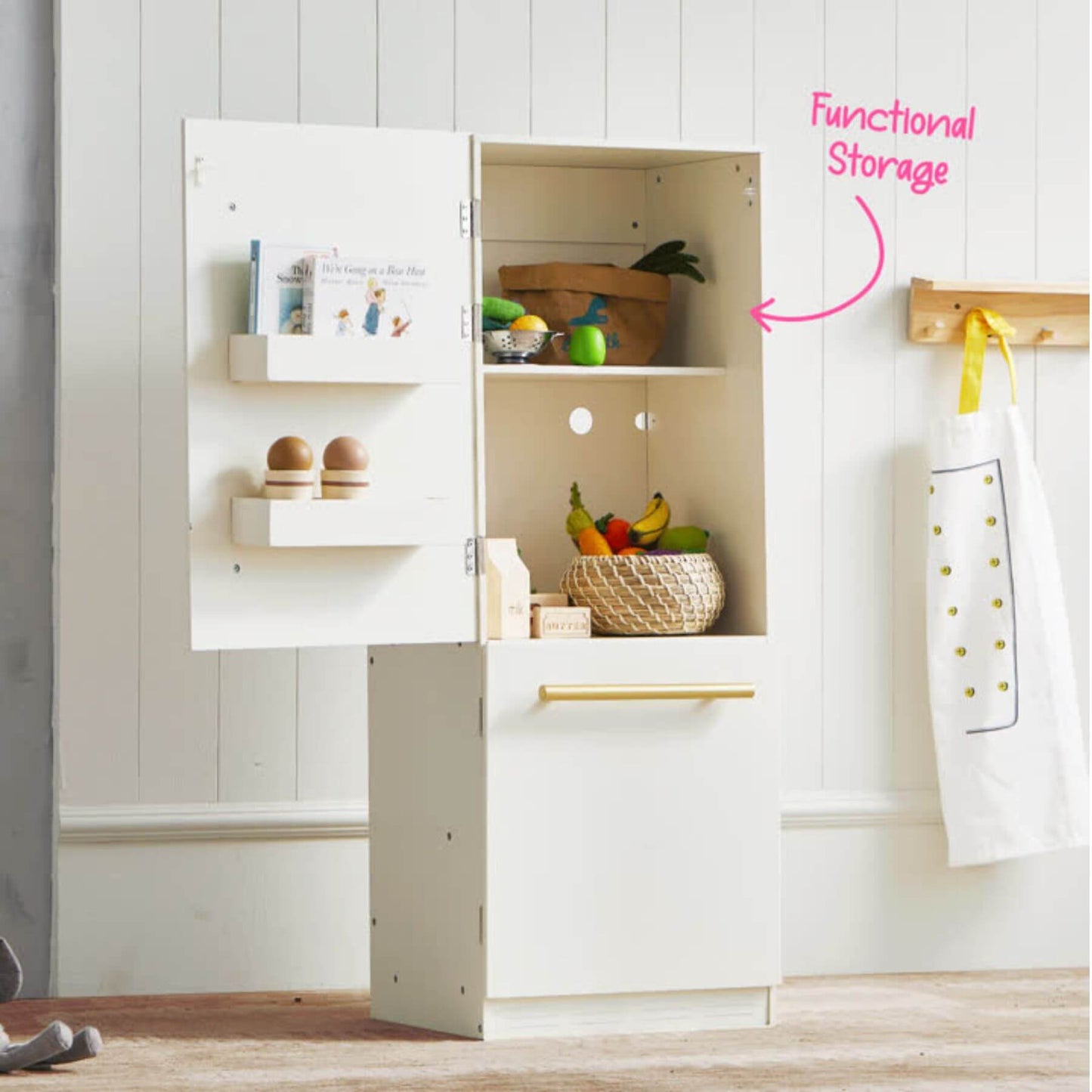 Tiny Land® Cabinet Play Fridge with open cabinet displaying various items, including a towel hanging on a hook.