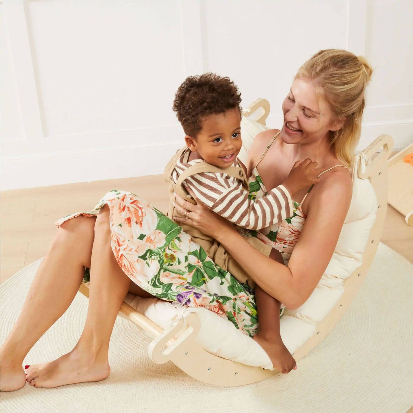 Mom Holding Baby Sitting on Rocker
