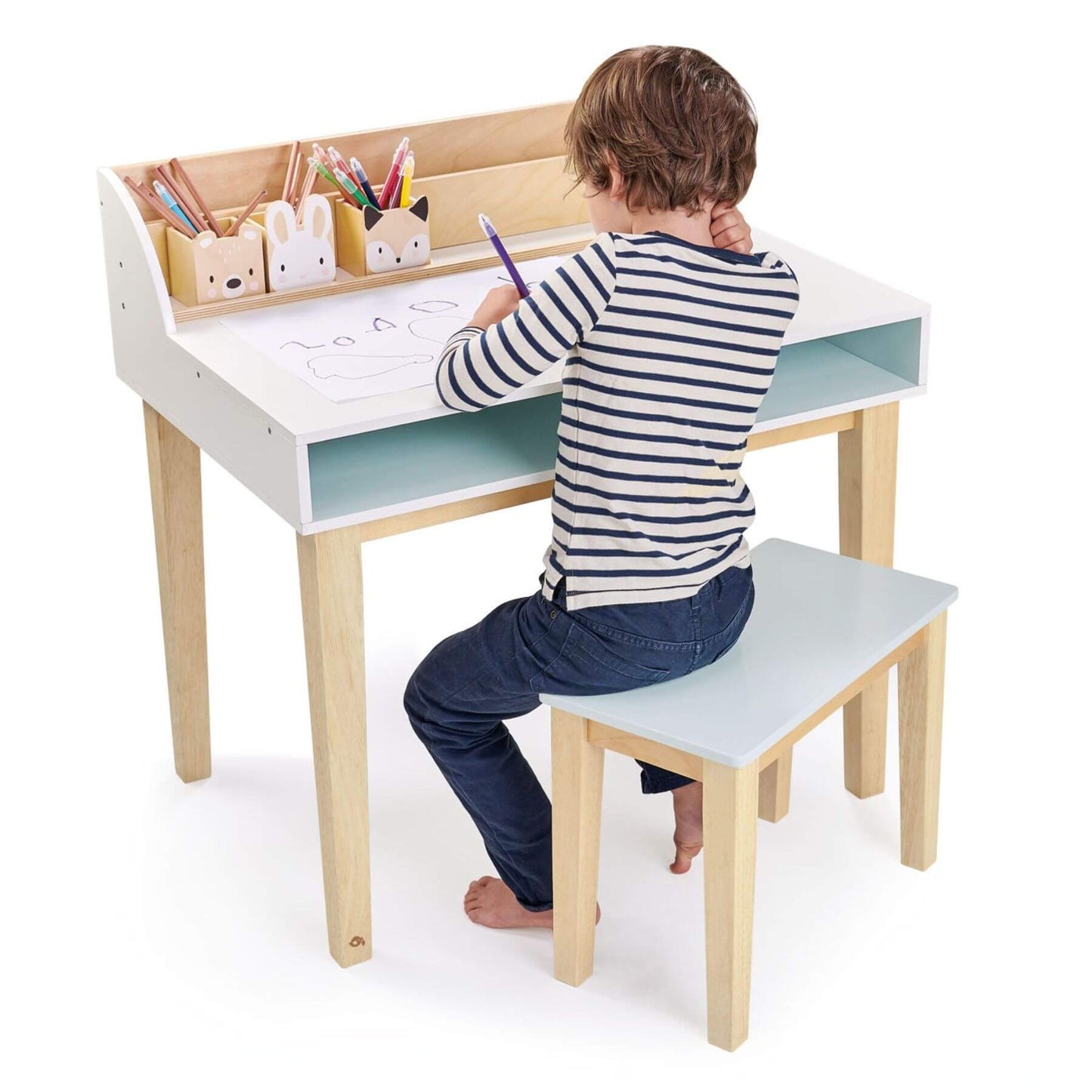 Child sitting at Tender Leaf Desk and Chair, drawing with colorful pencils.