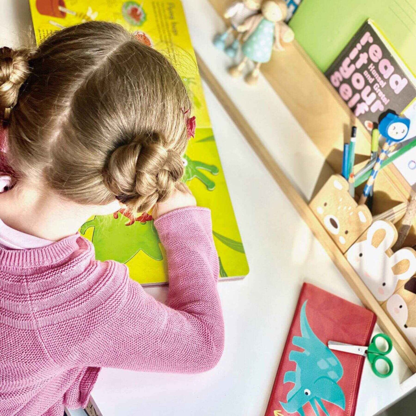 Child engaged in an educational activity with colorful materials on a desk.