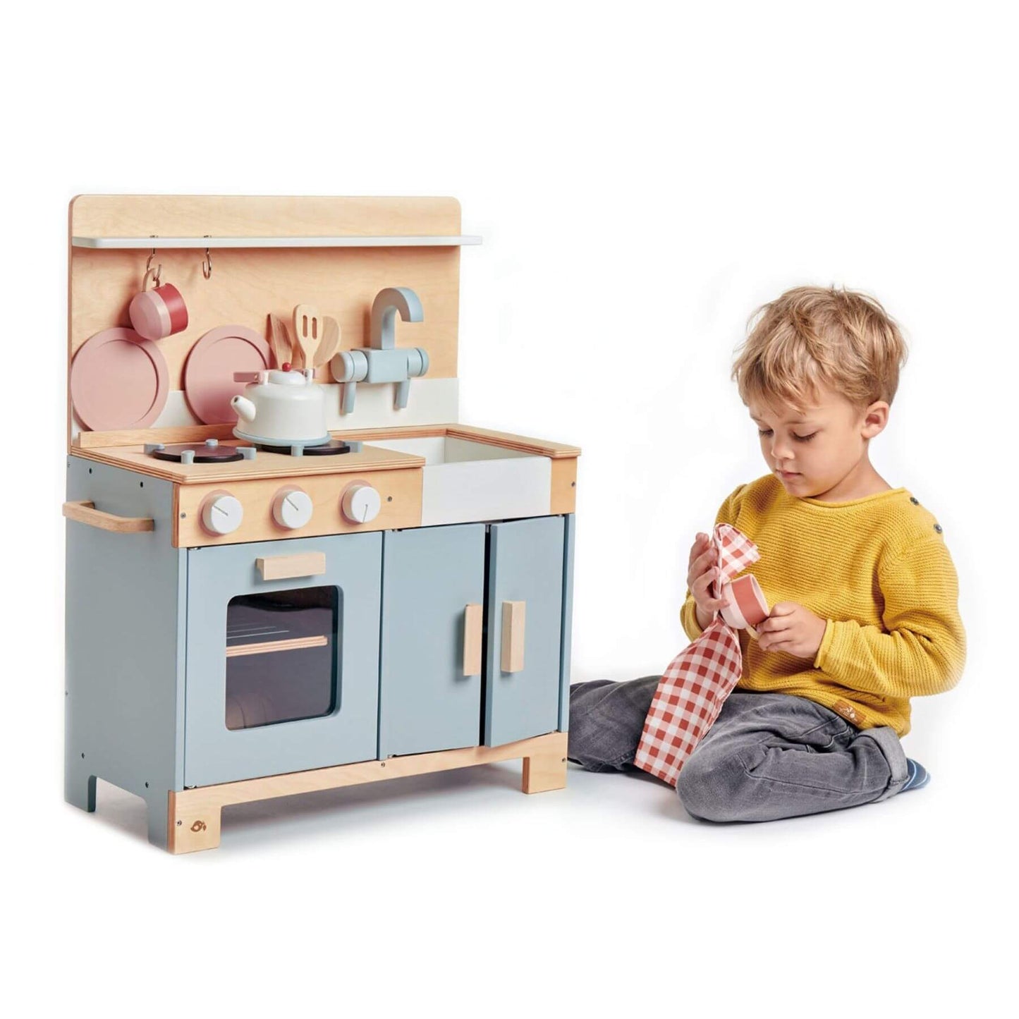 Child playing with Tender Leaf Home Kitchen on a white background